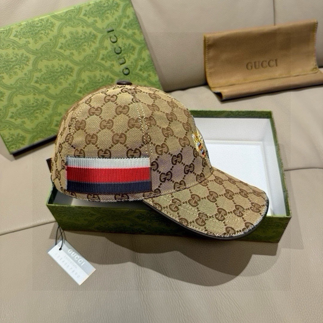 Gucci Original GG canvas baseball hat with Web detail and brown leather trim.