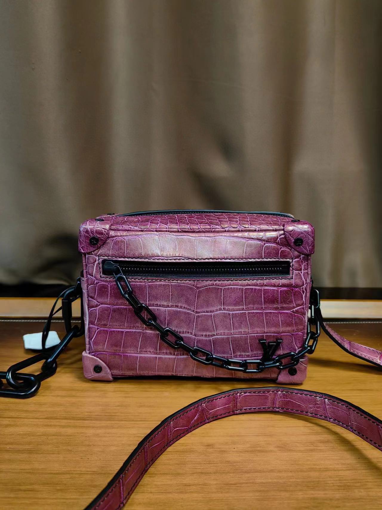 LV Mini Soft Trunk bag in purple crocodile leather.