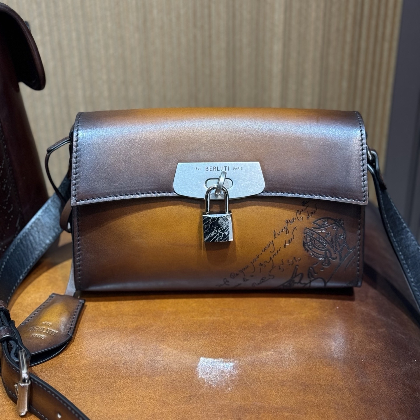 Berluti E'Mio Scritto leather messenger bag in brown.