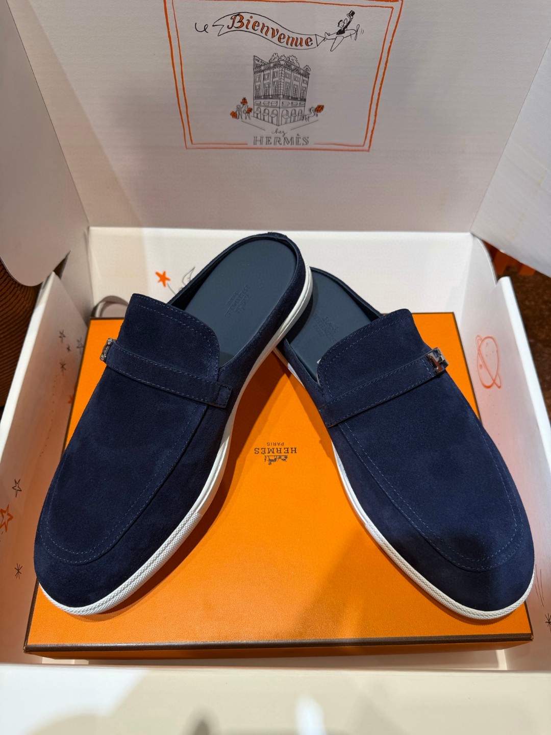 Hermès Likely mules in marine blue suede calfskin with a rubber sole