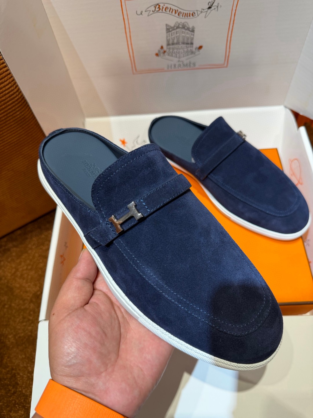 Hermès Likely mules in marine blue suede calfskin with a rubber sole