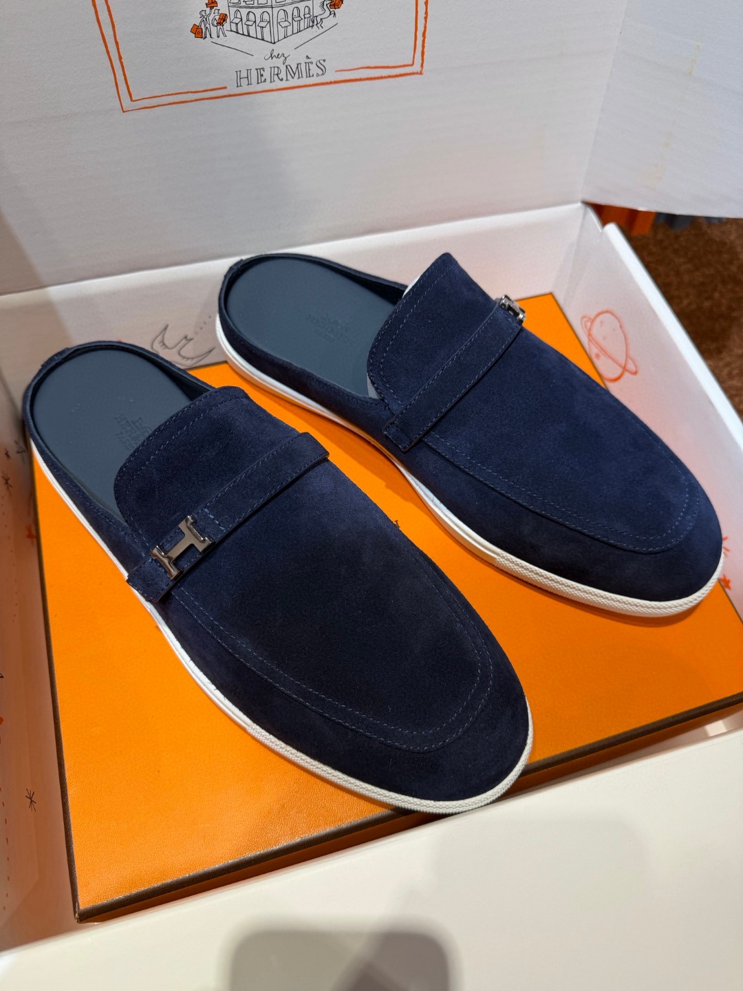 Hermès Likely mules in marine blue suede calfskin with a rubber sole