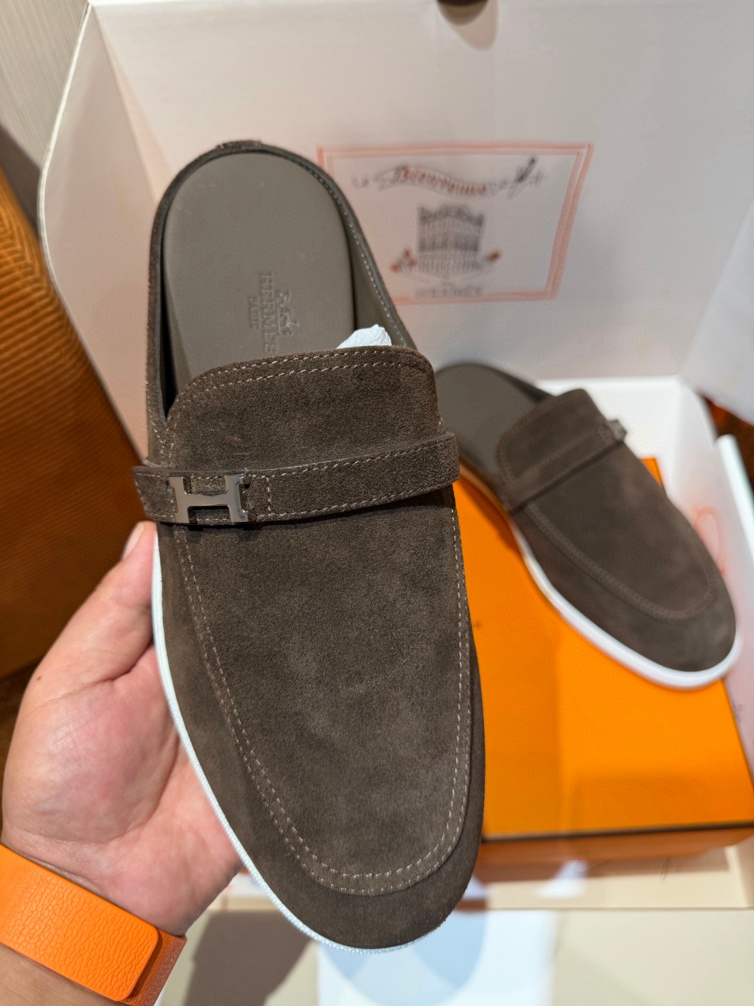 Hermès Likely mule in Écorce brown suede with a palladium-plated H buckle and rubber sole