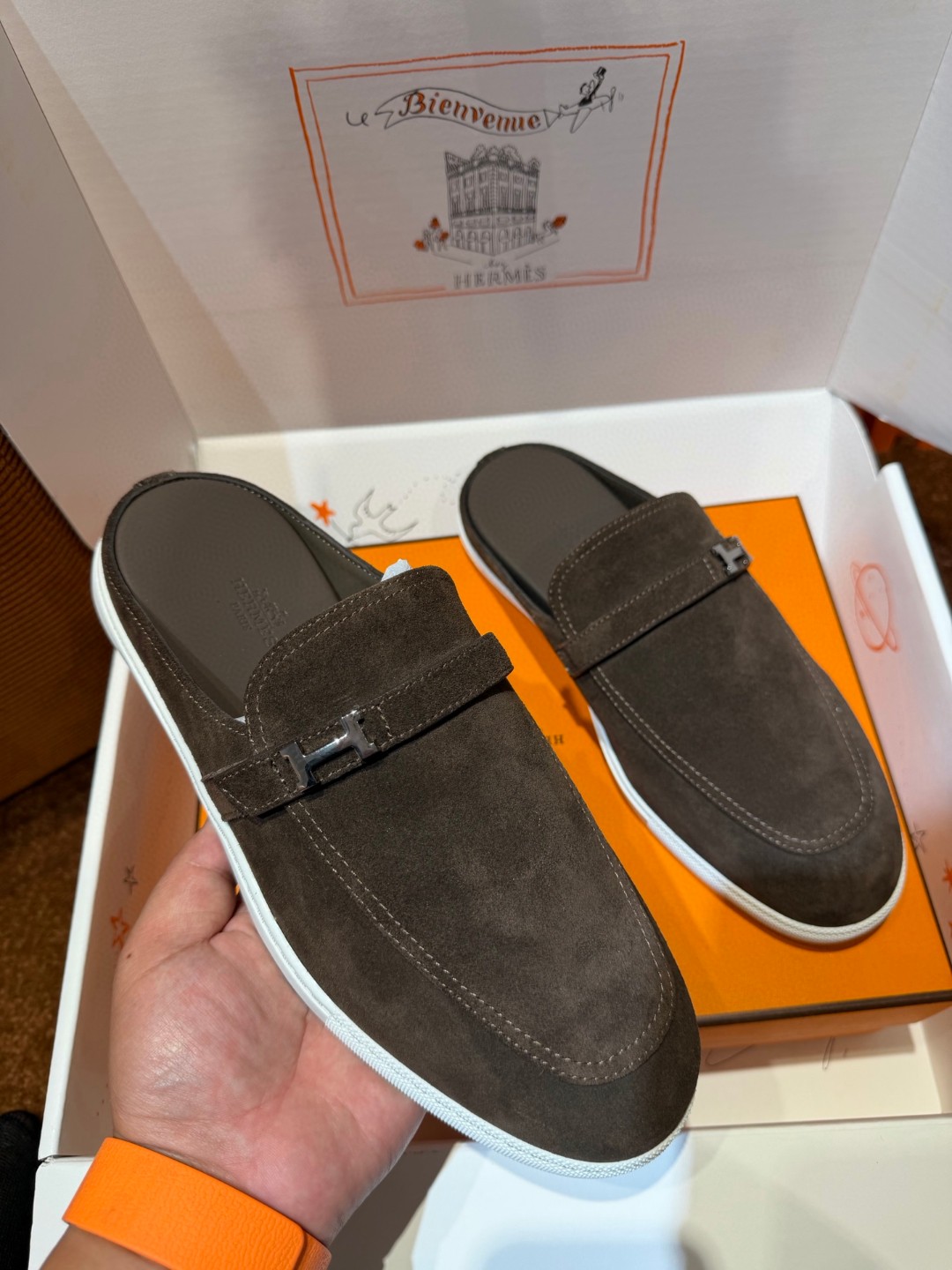 Hermès Likely mule in Écorce brown suede with a palladium-plated H buckle and rubber sole