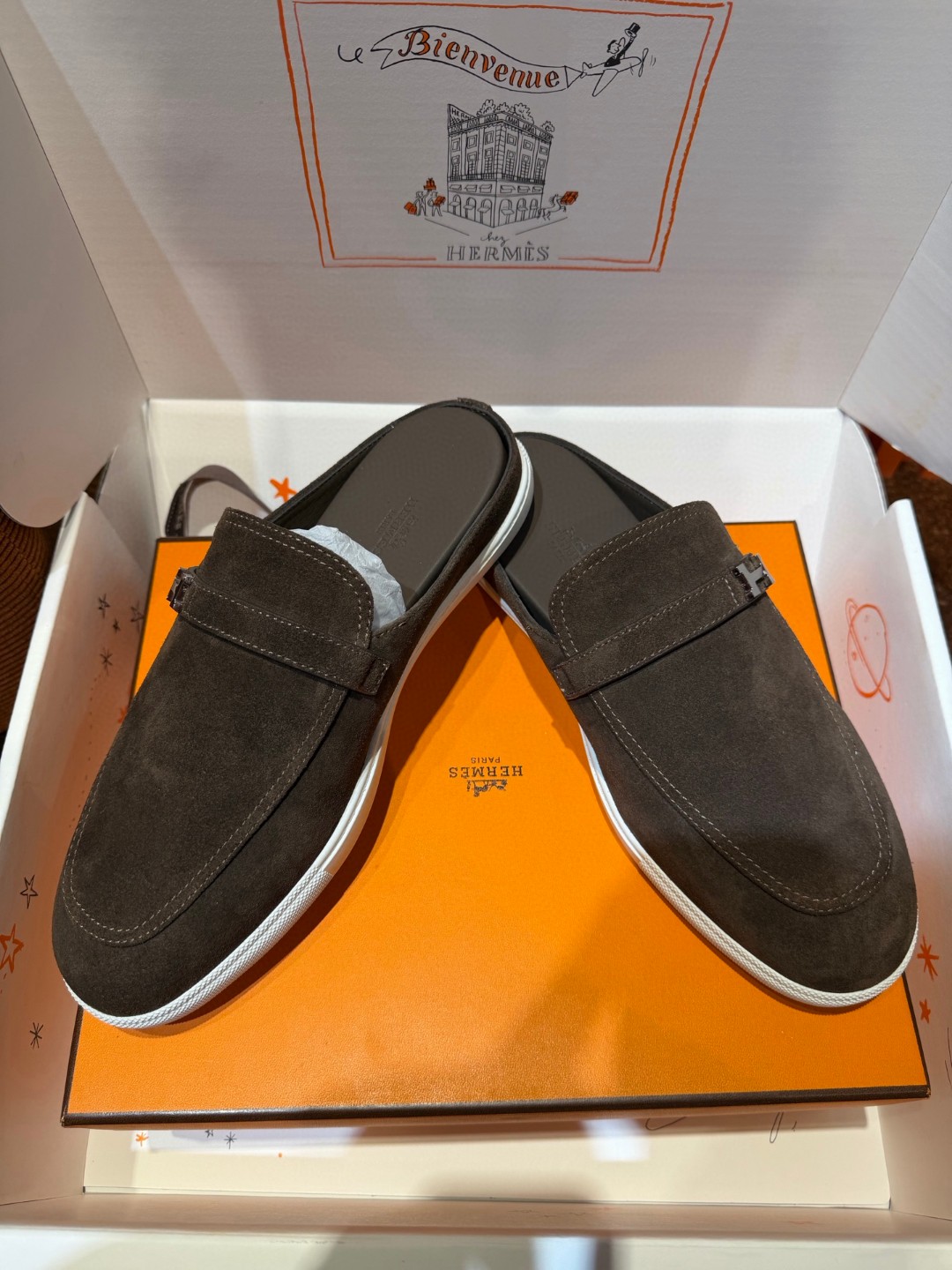 Hermès Likely mule in Écorce brown suede with a palladium-plated H buckle and rubber sole