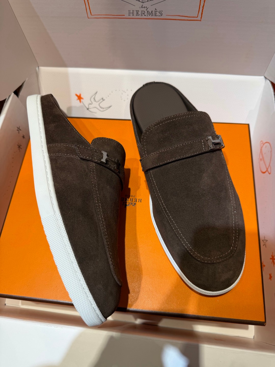 Hermès Likely mule in Écorce brown suede with a palladium-plated H buckle and rubber sole