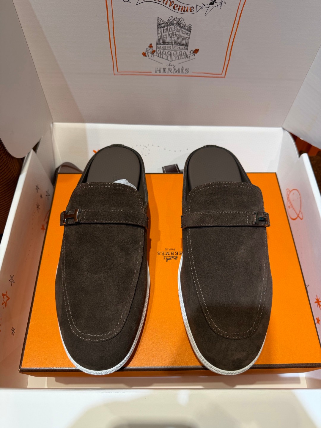 Hermès Likely mule in Écorce brown suede with a palladium-plated H buckle and rubber sole