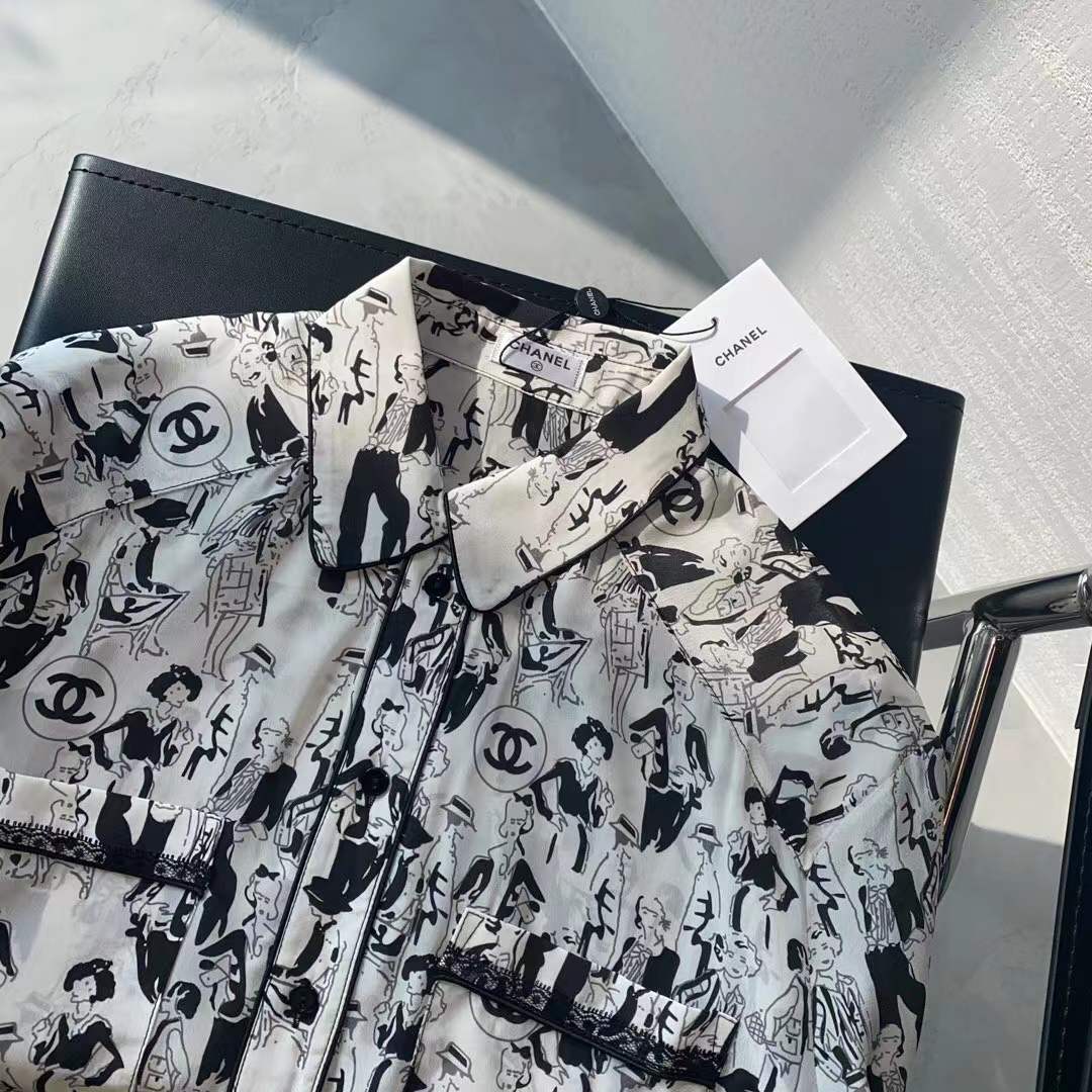 Channel white and black printed shirt featuring a classic collar and button closure