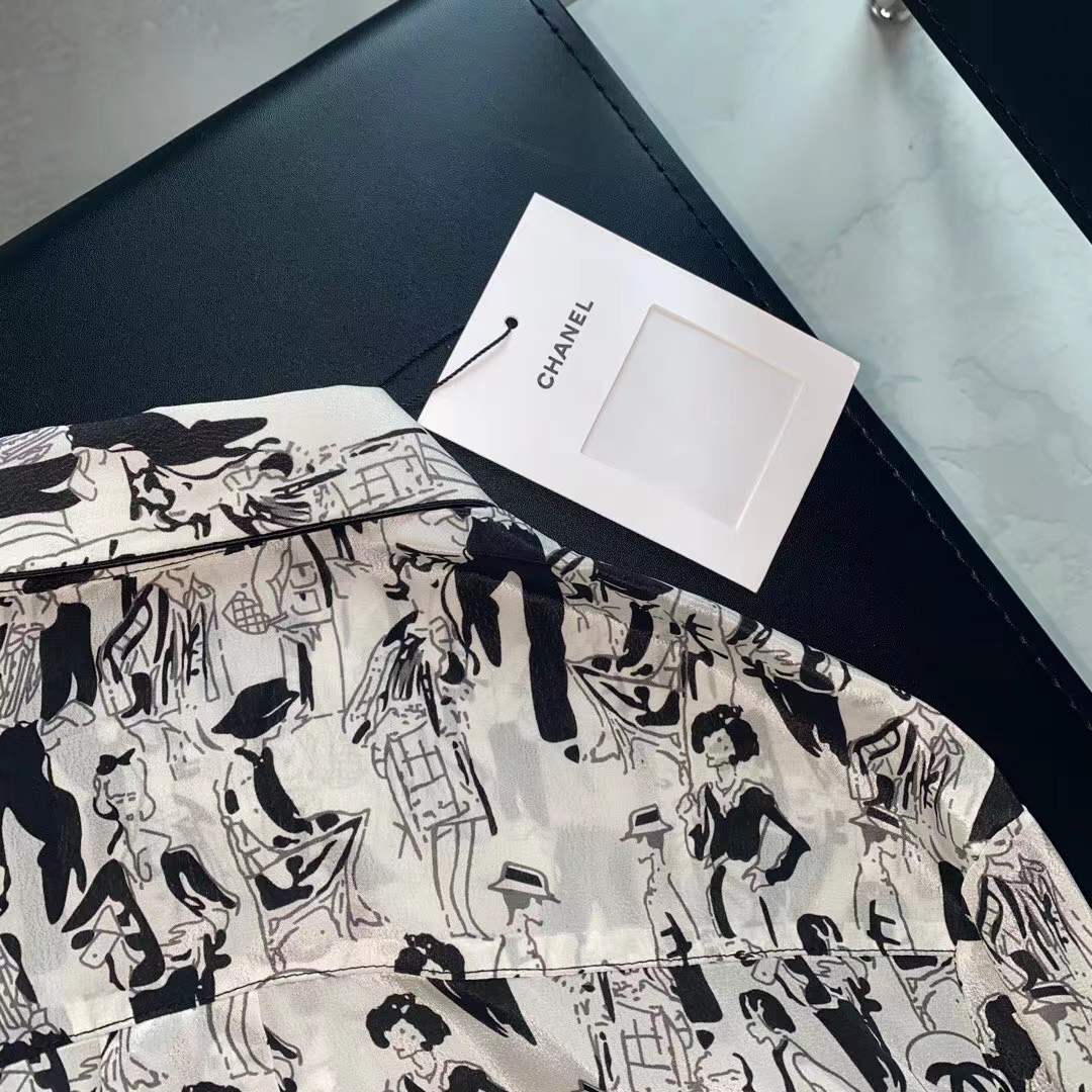 Channel white and black printed shirt featuring a classic collar and button closure