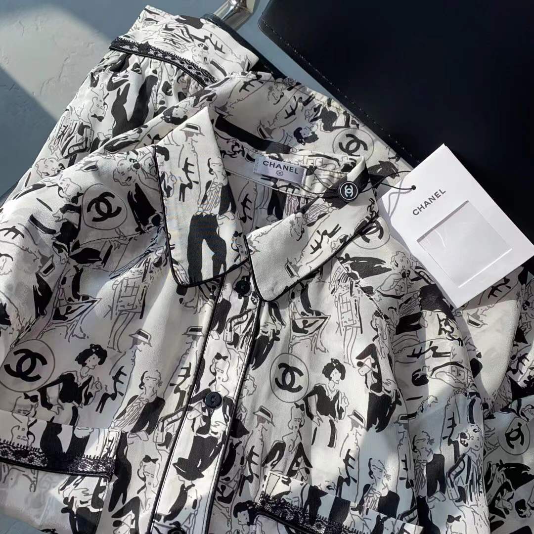 Channel white and black printed shirt featuring a classic collar and button closure