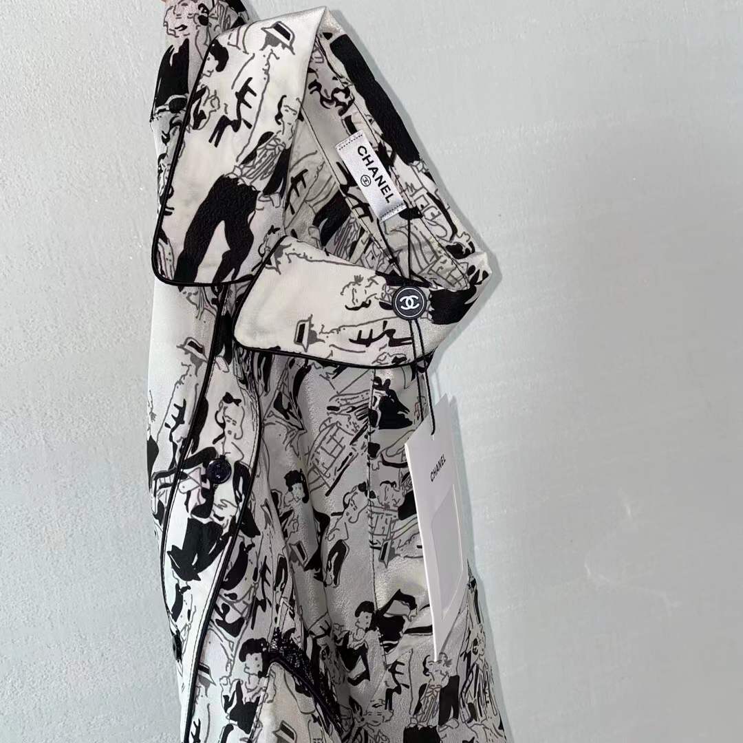 Channel white and black printed shirt featuring a classic collar and button closure