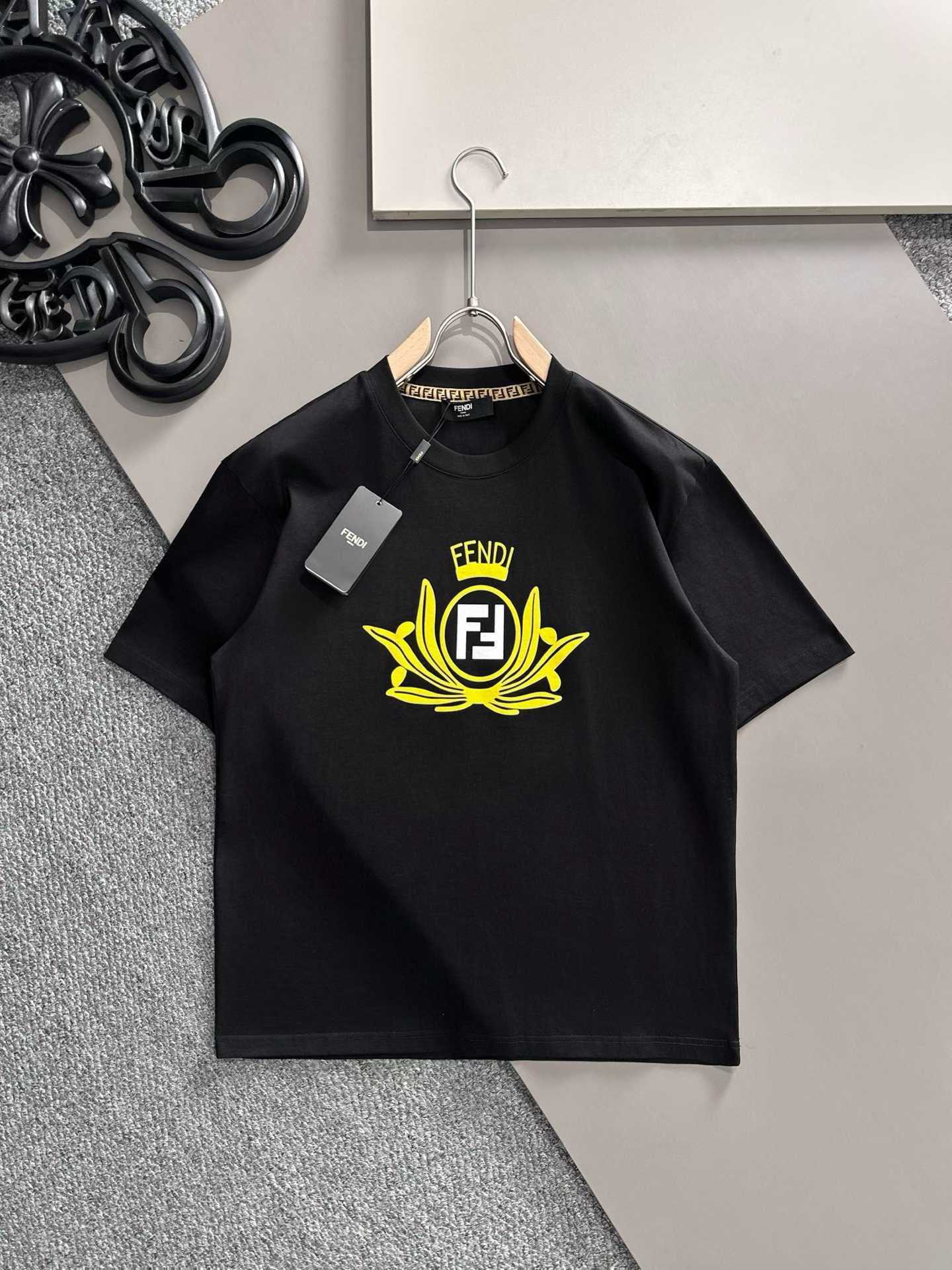 Fendi crew-neck T-shirt in black cotton featuring a yellow graphic crest and the signature FF logo