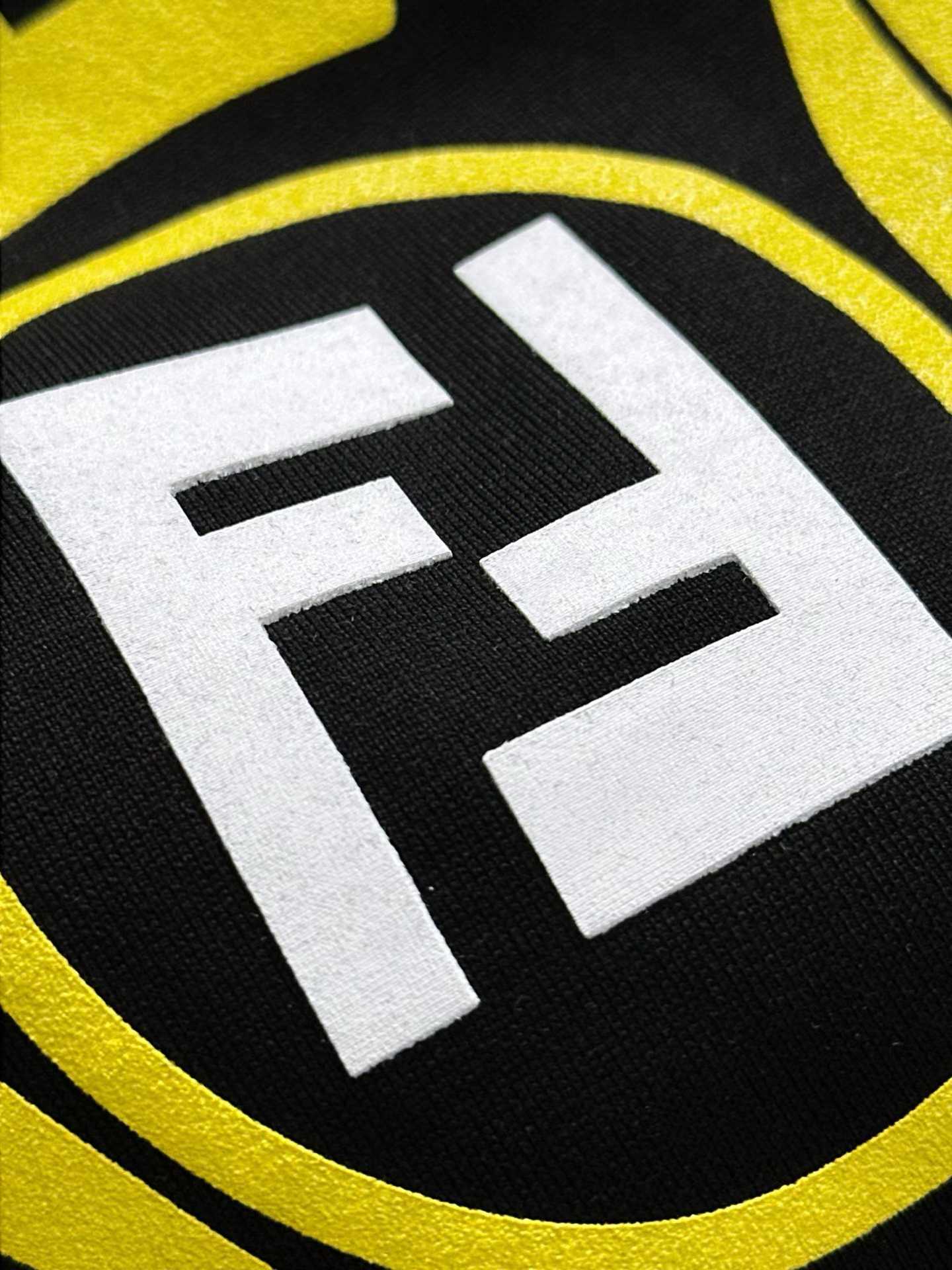 Fendi crew-neck T-shirt in black cotton featuring a yellow graphic crest and the signature FF logo