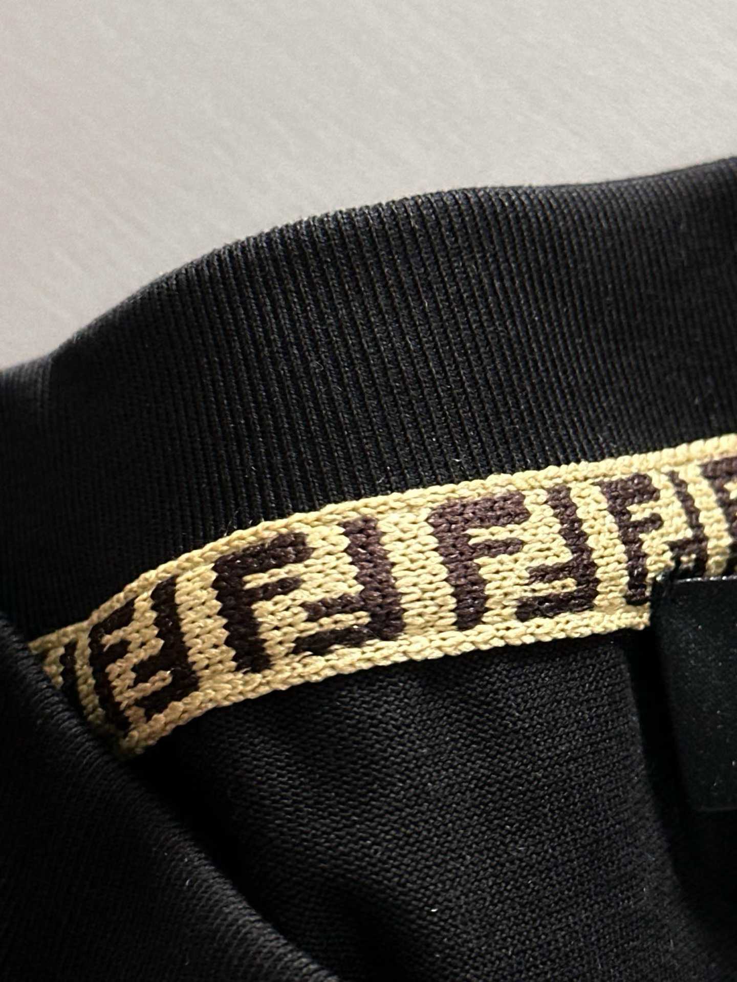 Fendi crew-neck T-shirt in black cotton featuring a yellow graphic crest and the signature FF logo