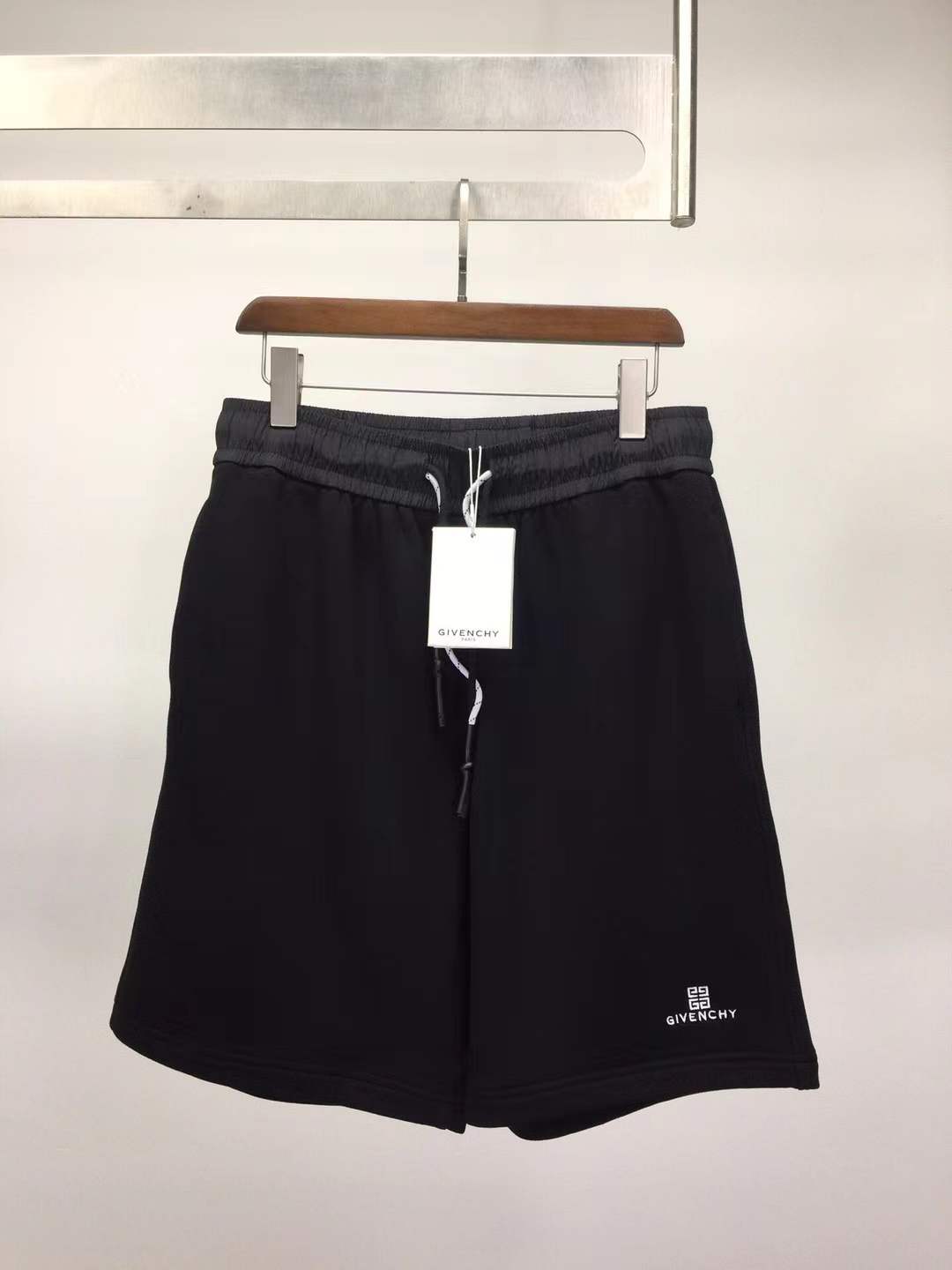 Givenchy black cotton or fleece blend shorts with an elasticated drawstring waistband and a logo print on the leg