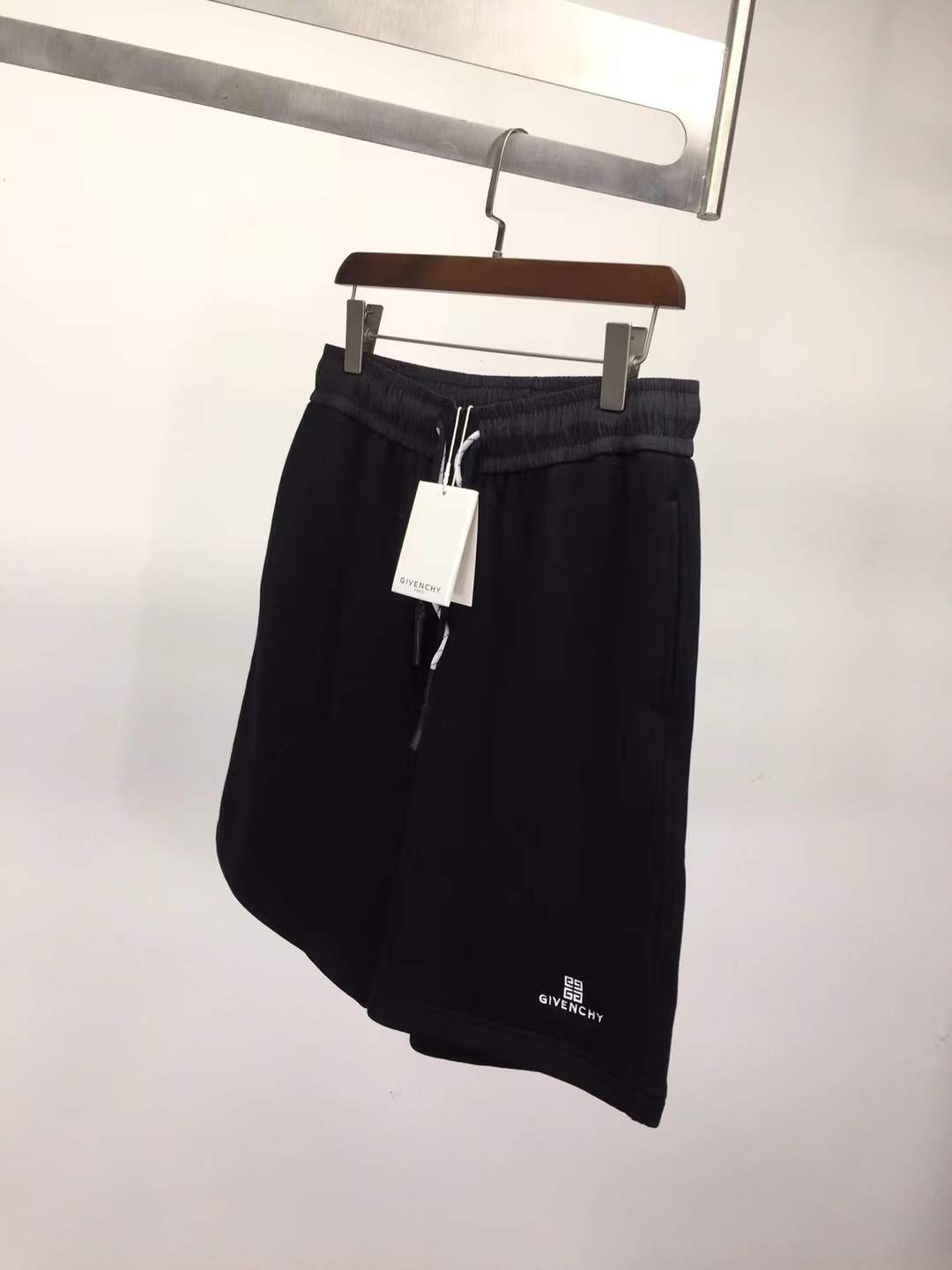 Givenchy black cotton or fleece blend shorts with an elasticated drawstring waistband and a logo print on the leg