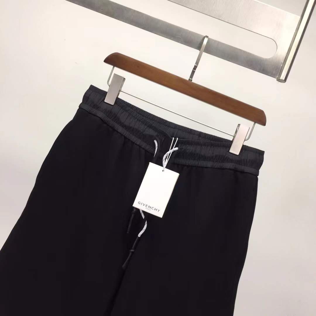 Givenchy black cotton or fleece blend shorts with an elasticated drawstring waistband and a logo print on the leg