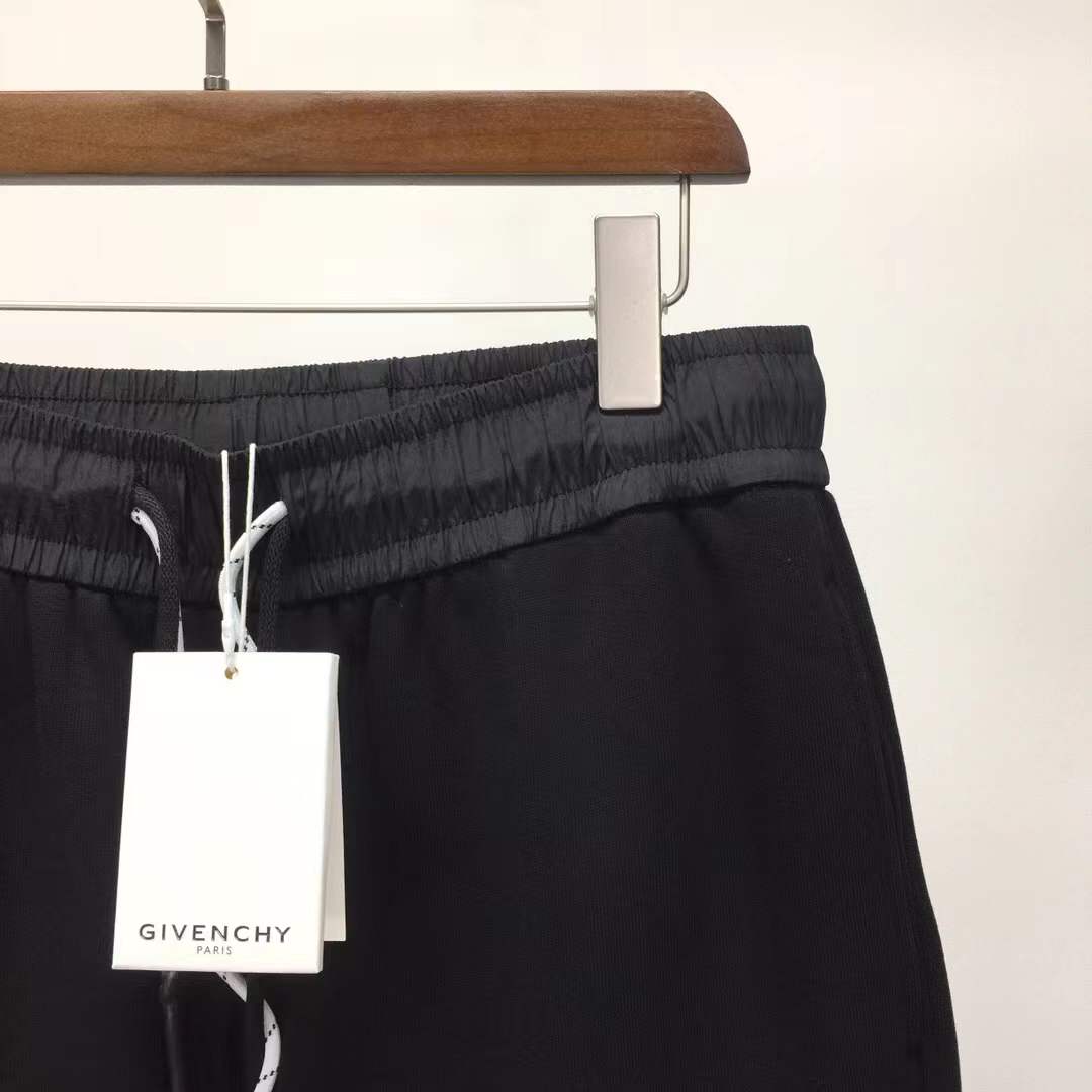 Givenchy black cotton or fleece blend shorts with an elasticated drawstring waistband and a logo print on the leg