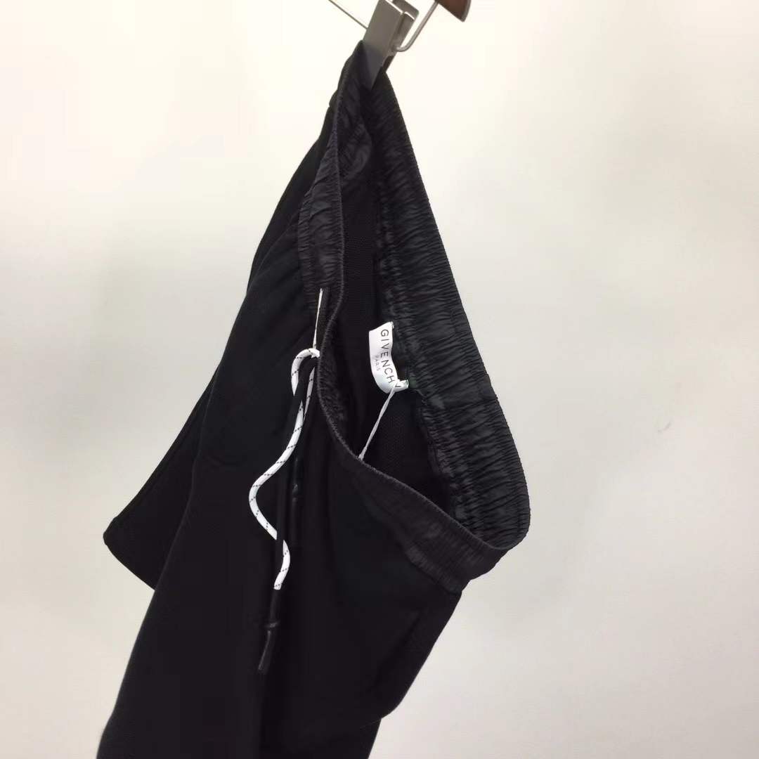 Givenchy black cotton or fleece blend shorts with an elasticated drawstring waistband and a logo print on the leg