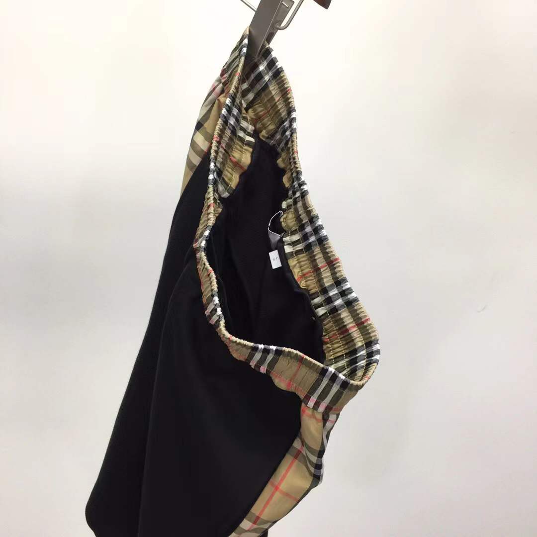 Burberry Kids black loopback cotton shorts with check side taping and an embroidered Equestrian Knight Design logo