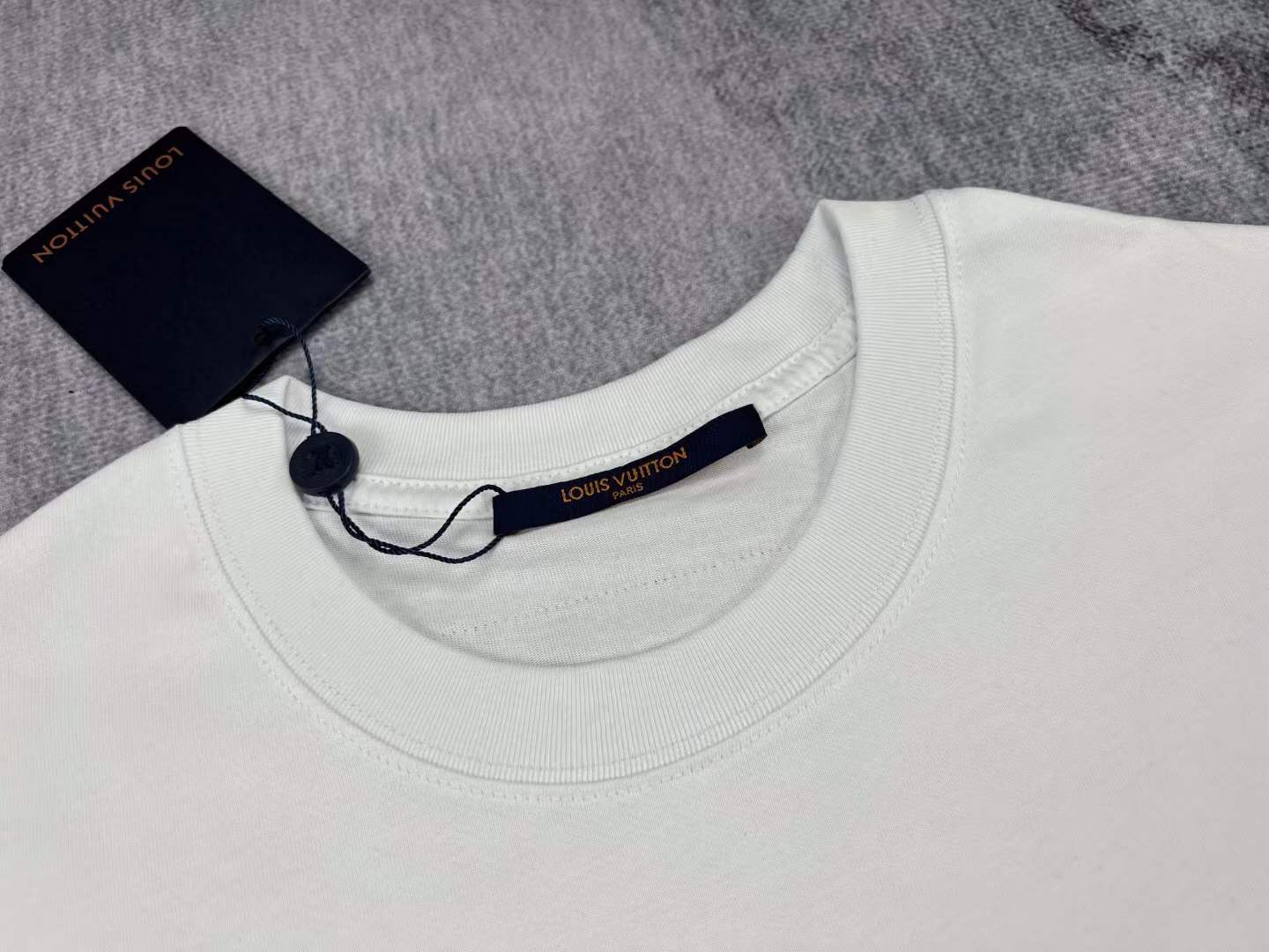 LV men's white t-shirt a green teddy bear graphic with the brand's Damier motif