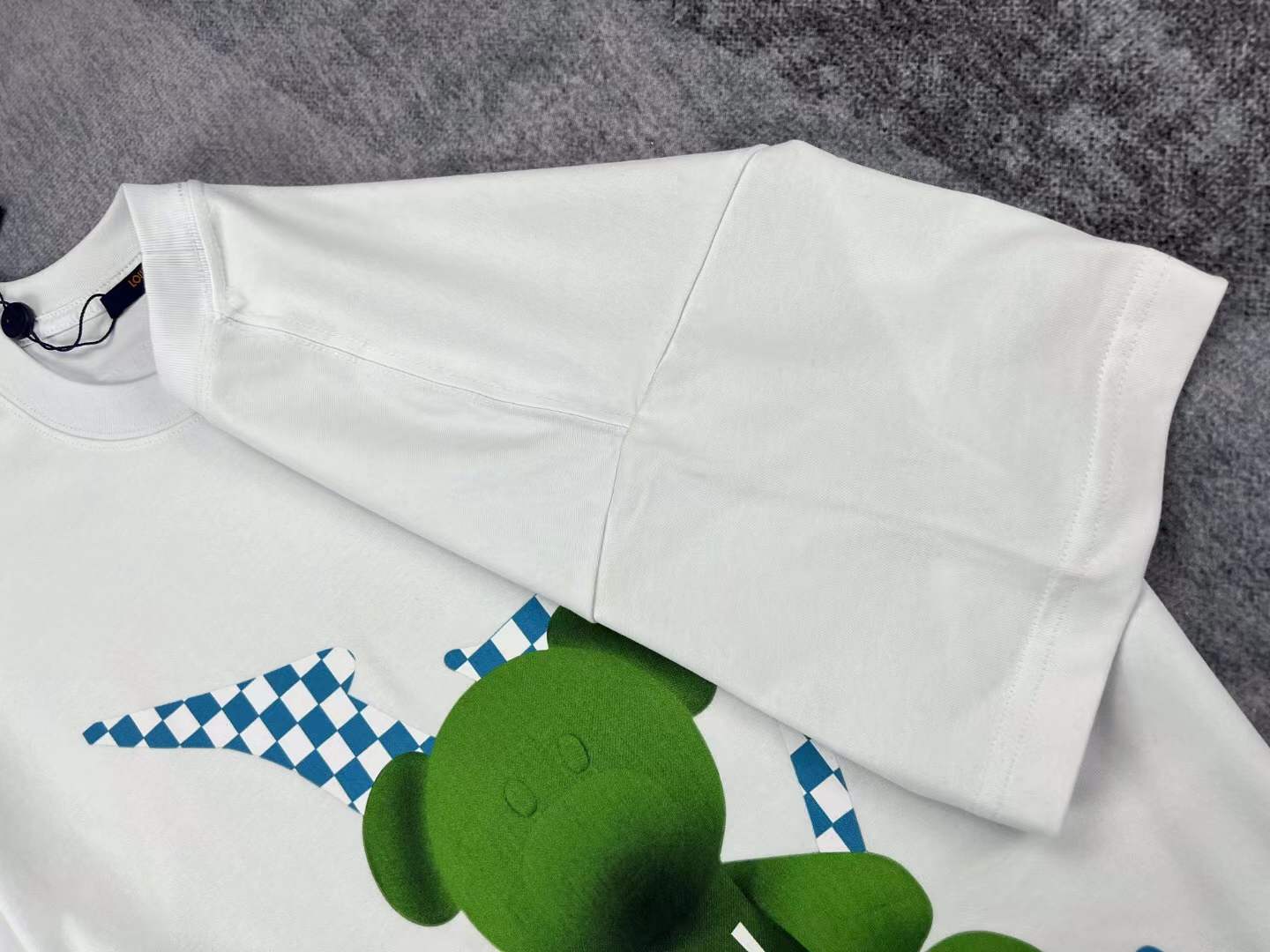 LV men's white t-shirt a green teddy bear graphic with the brand's Damier motif