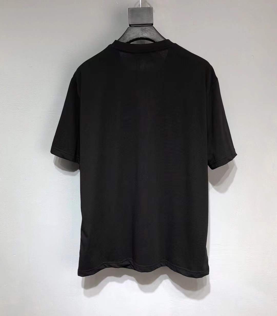 Prada Re-Nylon and jersey T-shirt black with a chest patch pocket and the signature enameled-metal triangle logo plaque.