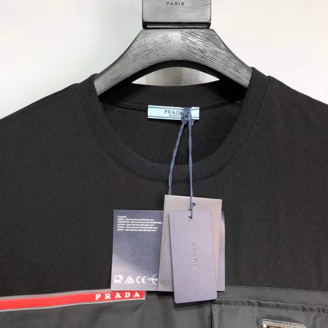 Prada Re-Nylon and jersey T-shirt black with a chest patch pocket and the signature enameled-metal triangle logo plaque.