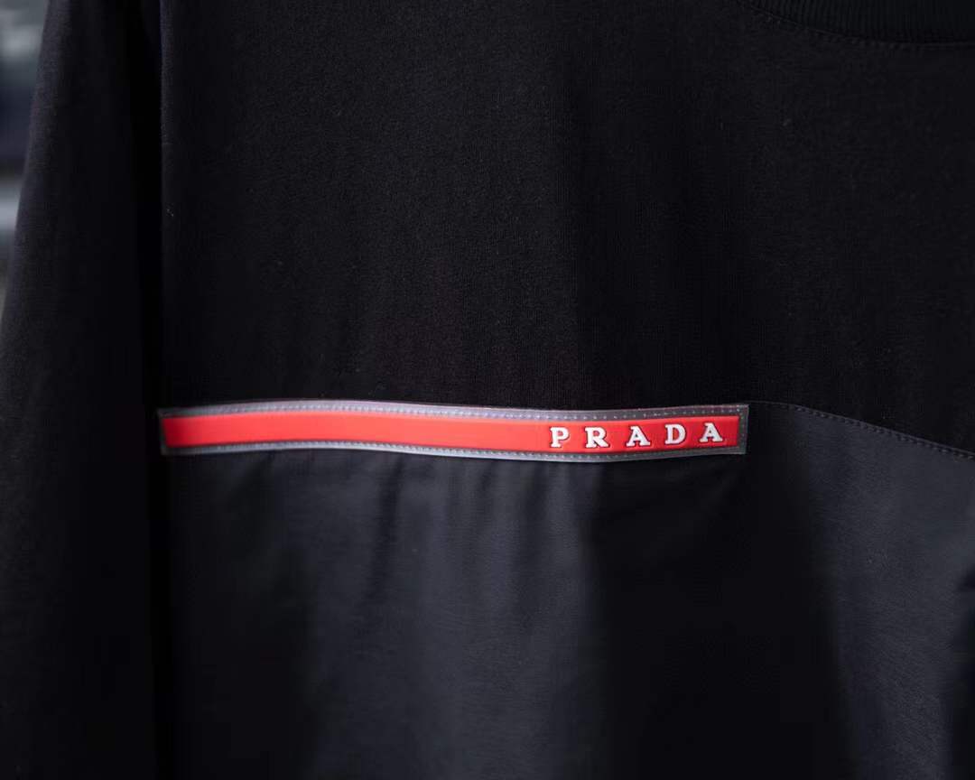 Prada Re-Nylon and jersey T-shirt black with a chest patch pocket and the signature enameled-metal triangle logo plaque.