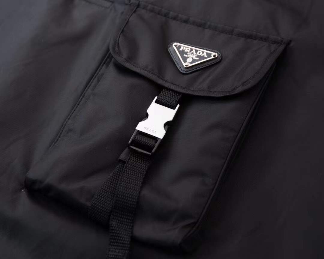 Prada Re-Nylon and jersey T-shirt black with a chest patch pocket and the signature enameled-metal triangle logo plaque.