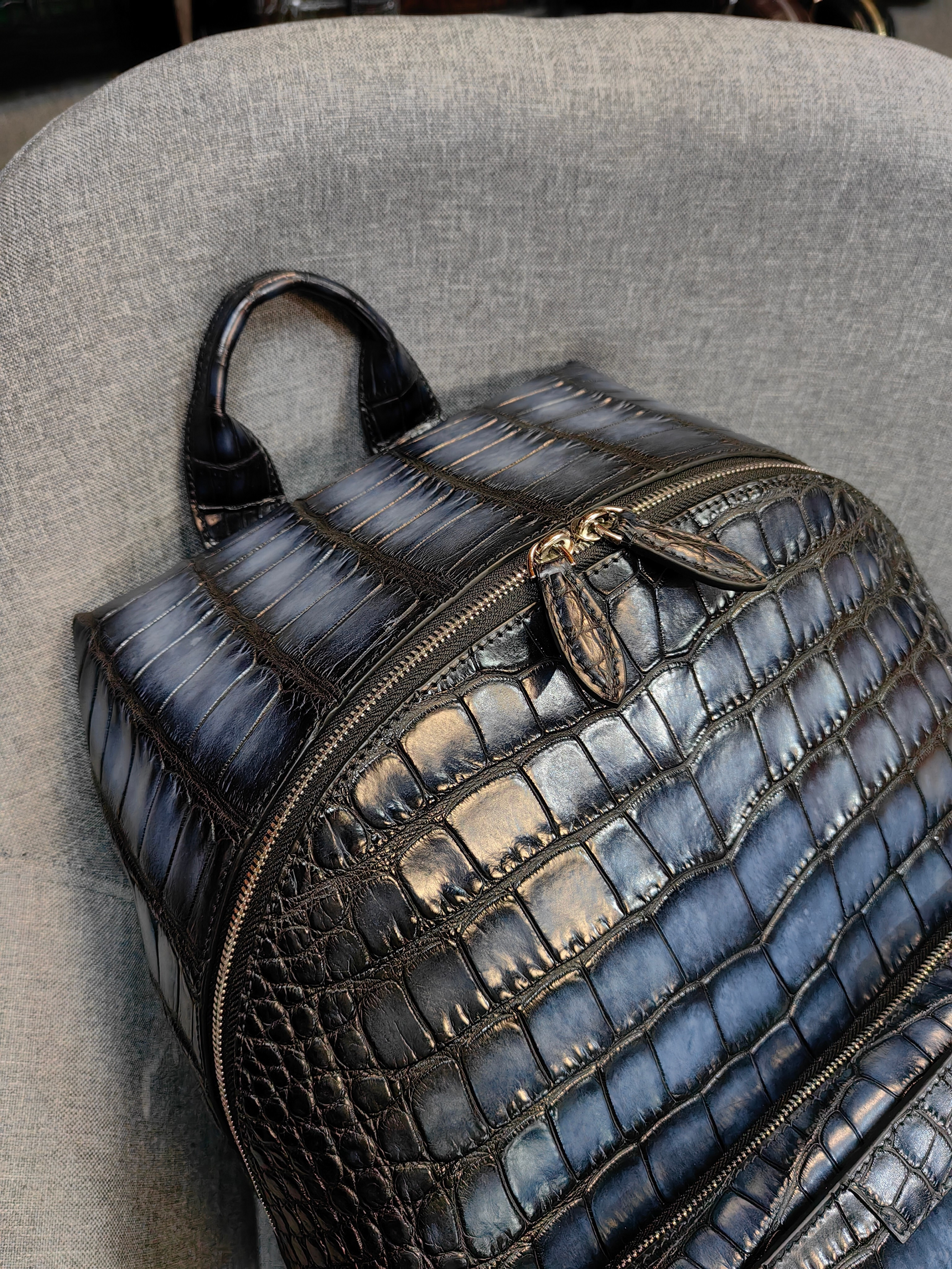 Berluti navy blue, crocodile-embossed leather backpack.