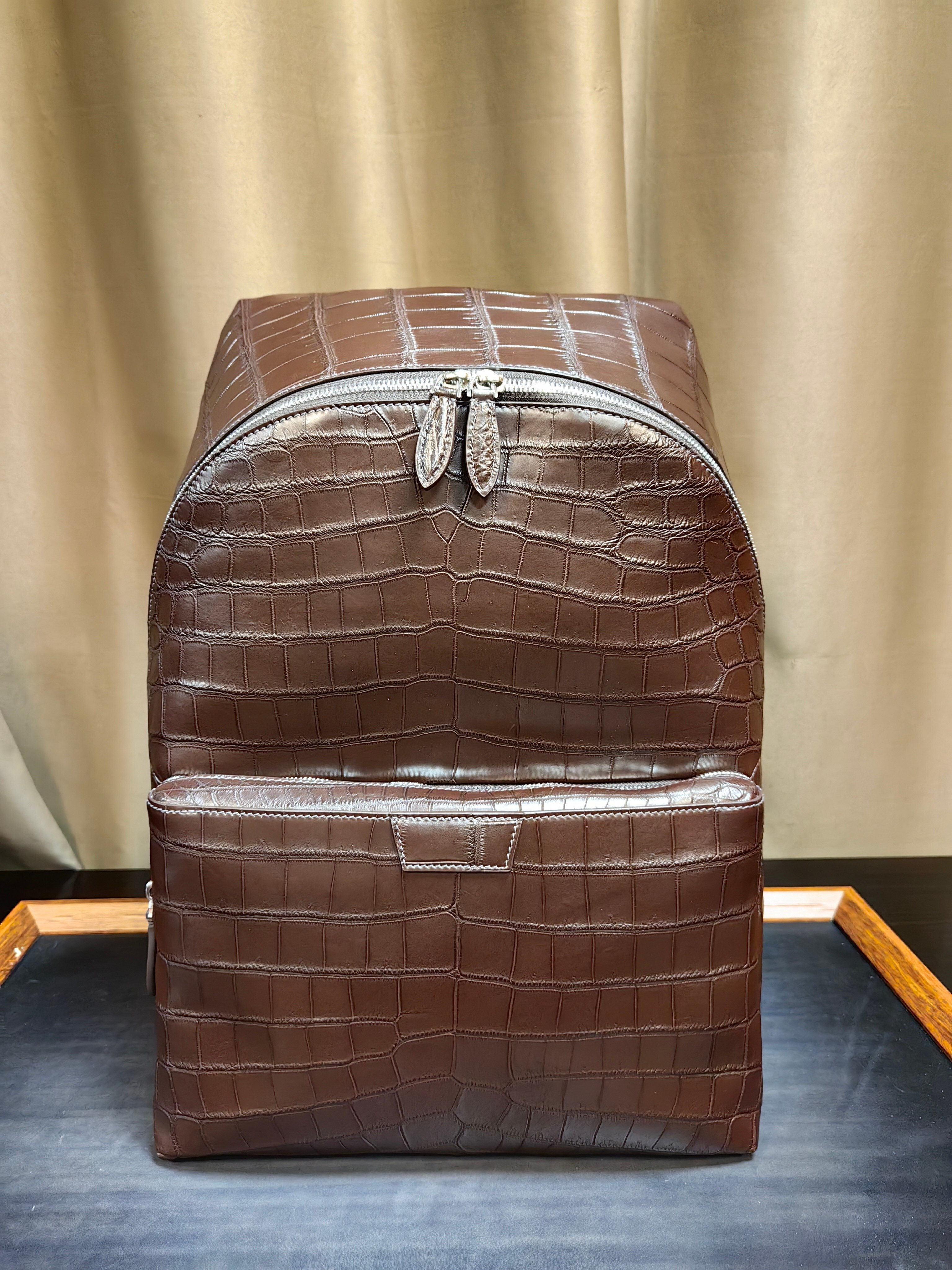 brown genuine leather backpack with a crocodile embossed texture