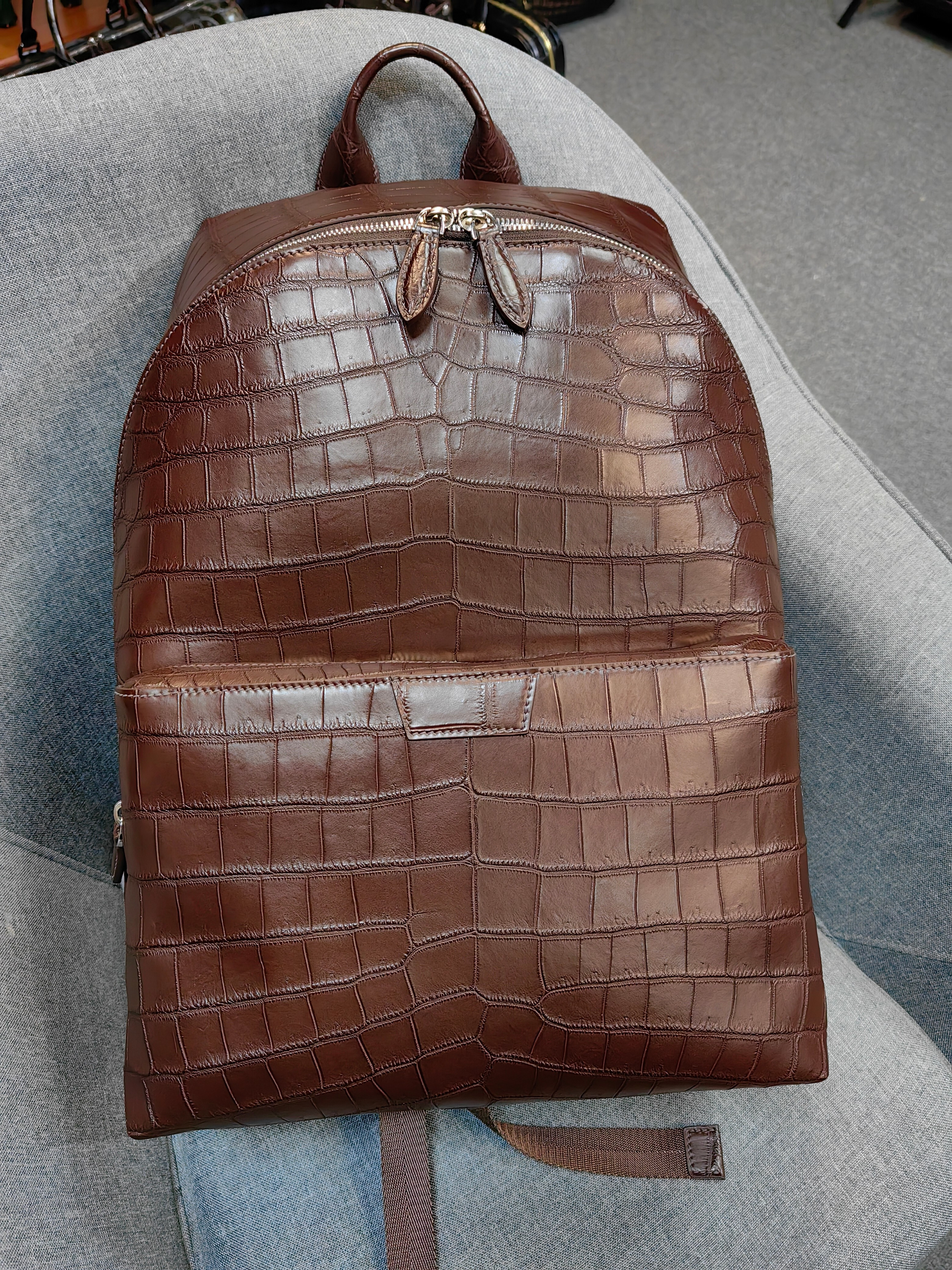 brown genuine leather backpack with a crocodile embossed texture