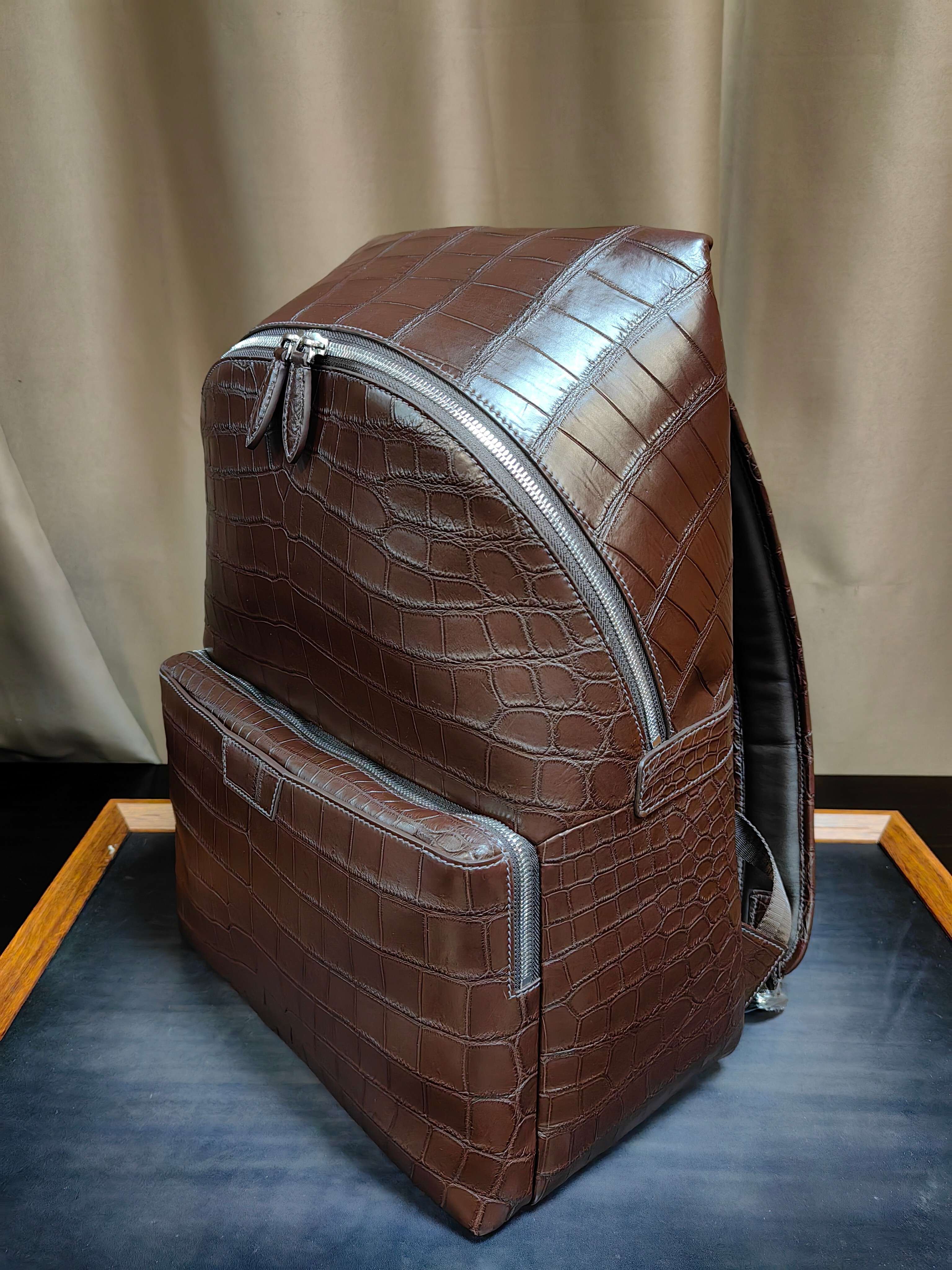 brown genuine leather backpack with a crocodile embossed texture