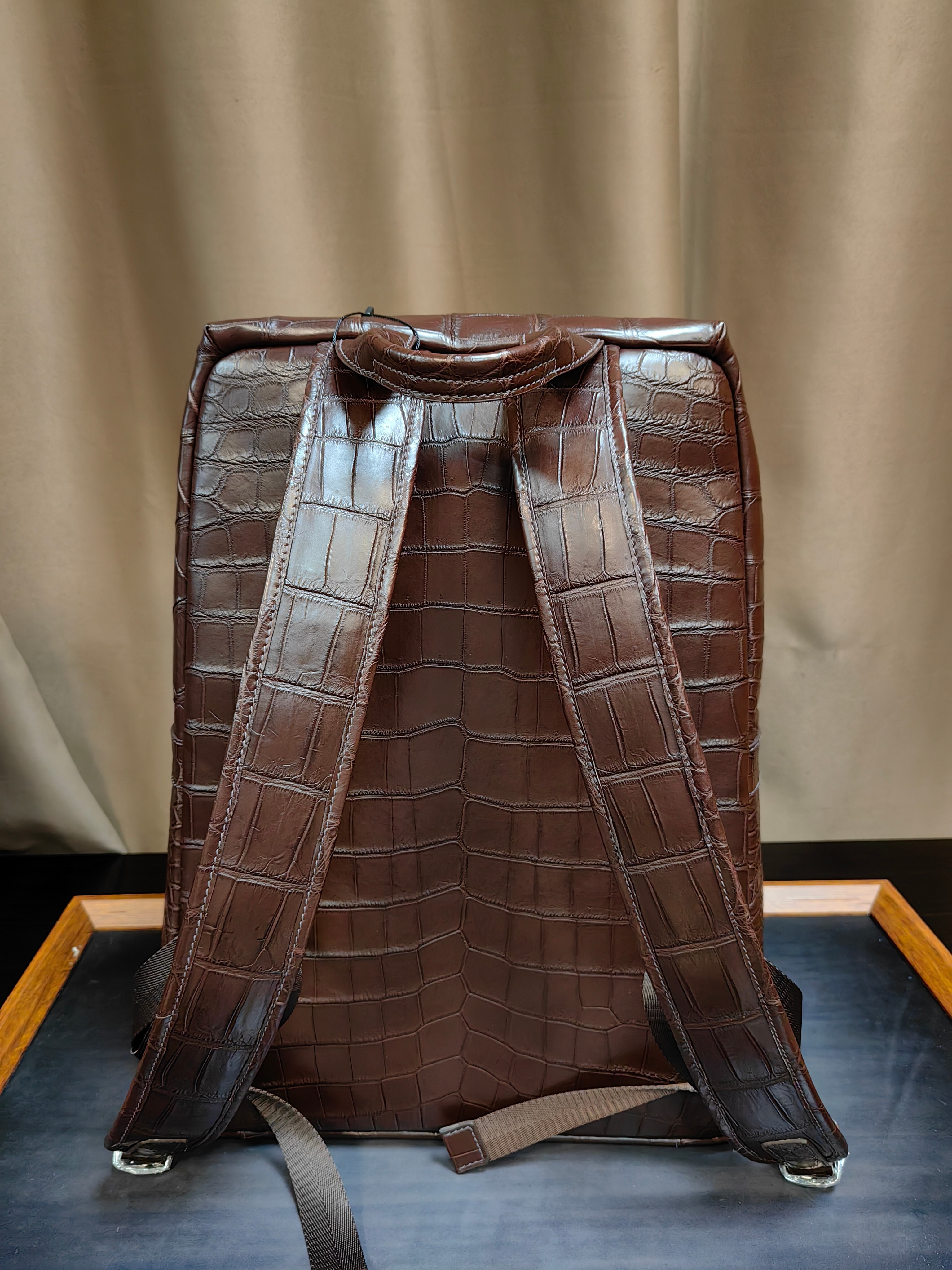 brown genuine leather backpack with a crocodile embossed texture
