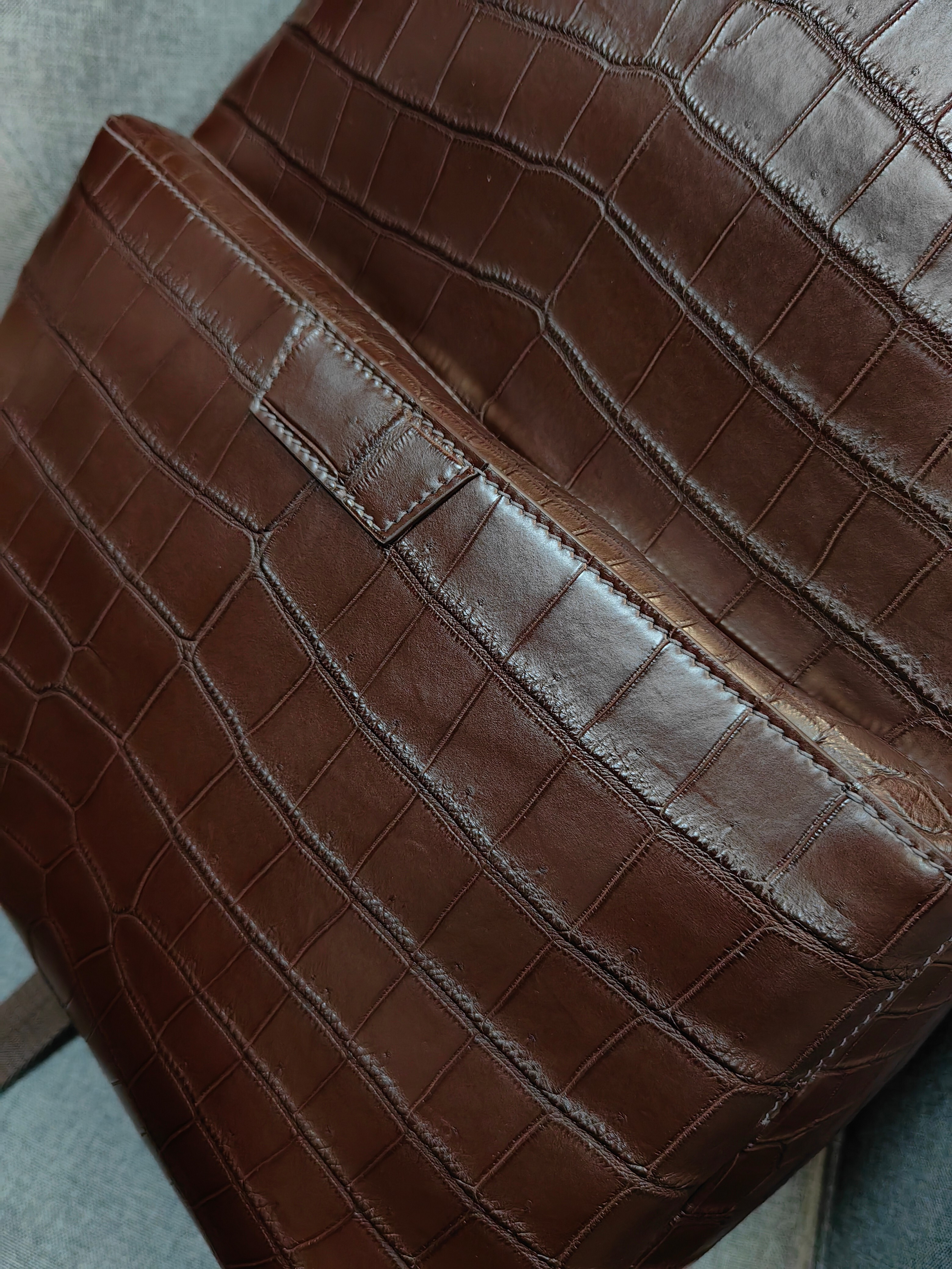 brown genuine leather backpack with a crocodile embossed texture