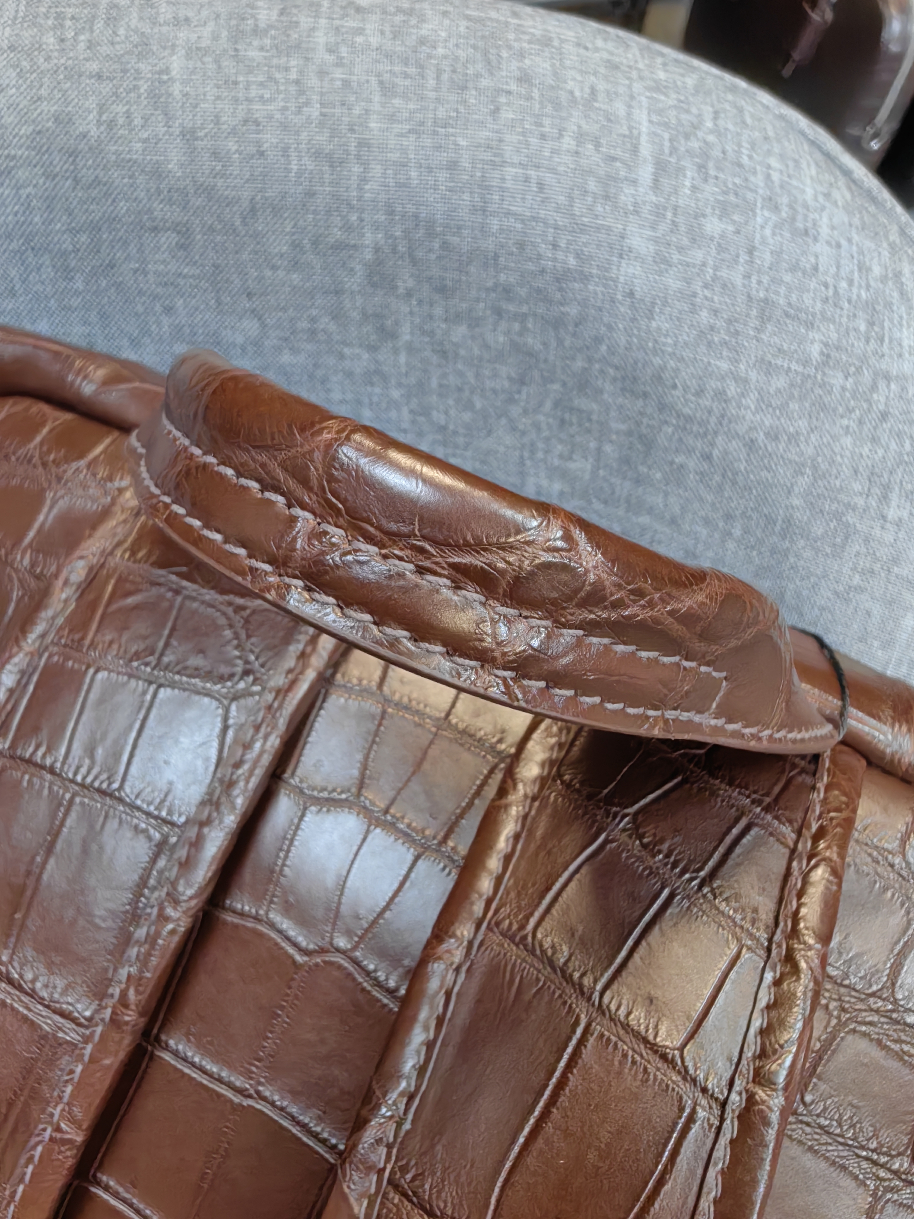 brown genuine leather backpack with a crocodile embossed texture