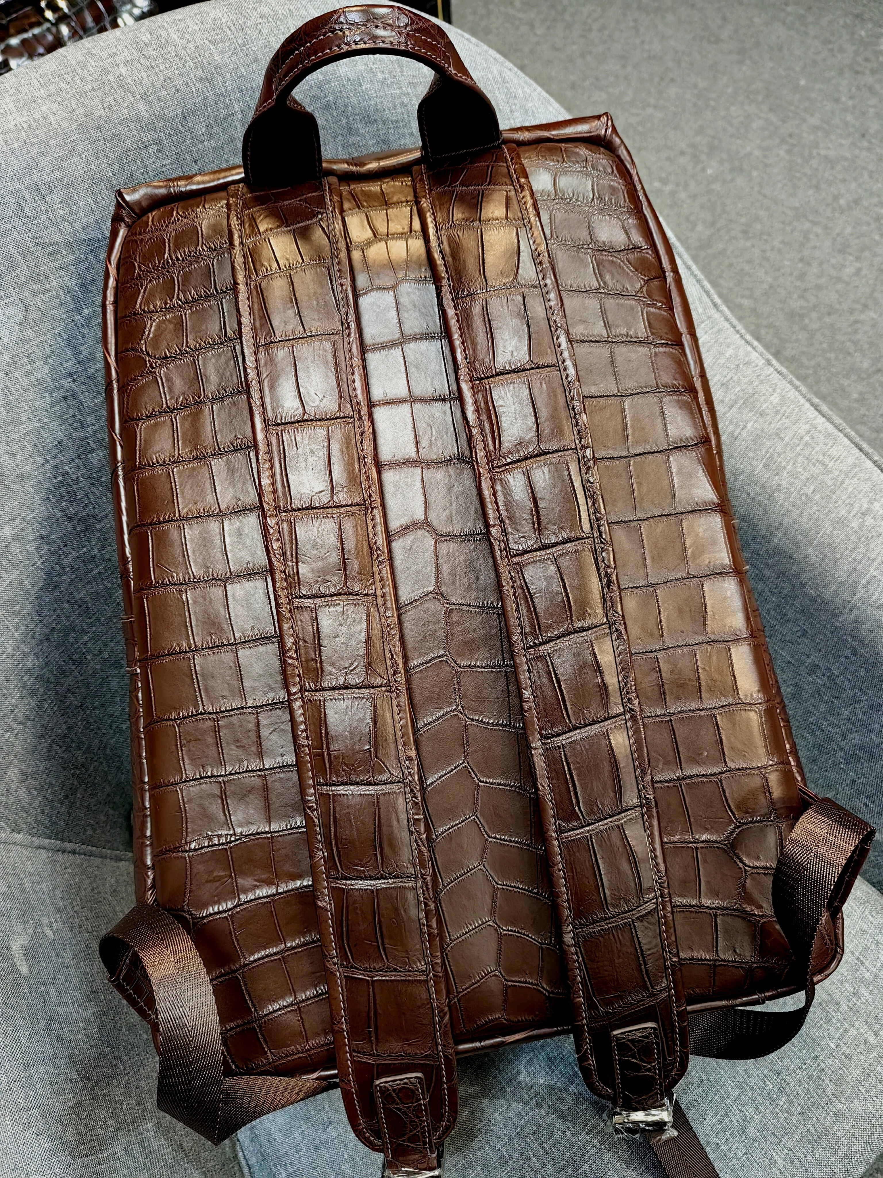 brown genuine leather backpack with a crocodile embossed texture