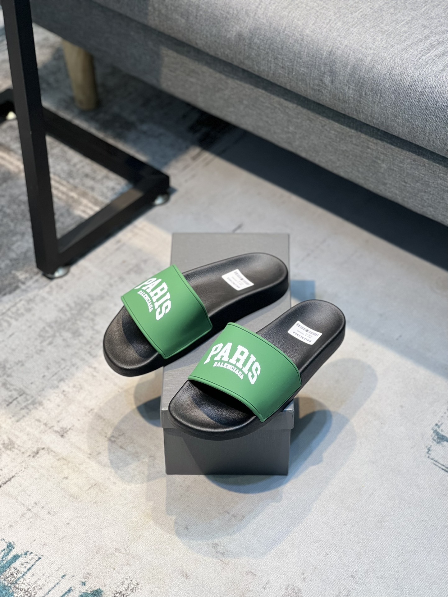 Balenciaga Paris pool slide sandals in green and black rubber.