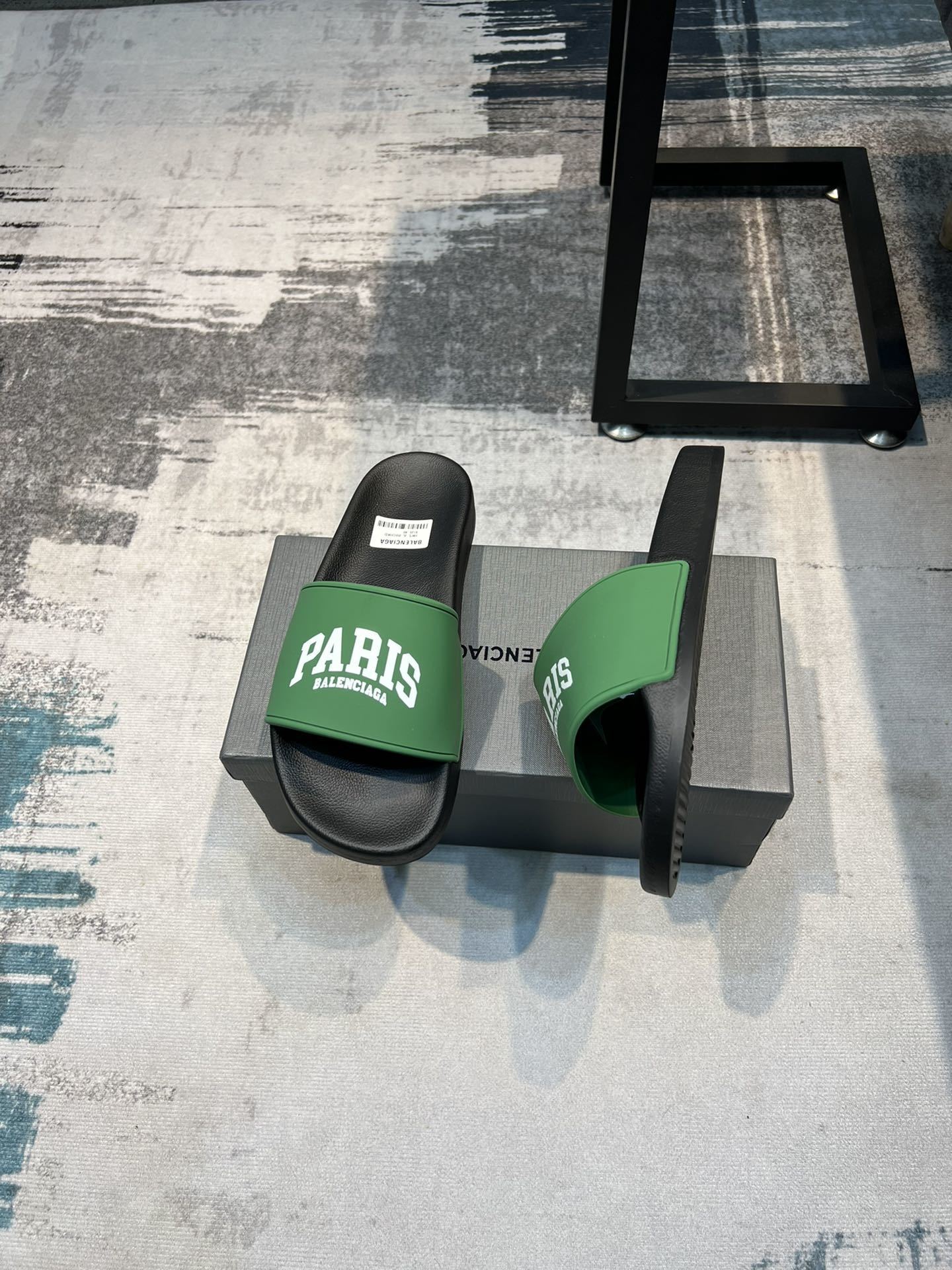 Balenciaga Paris pool slide sandals in green and black rubber.