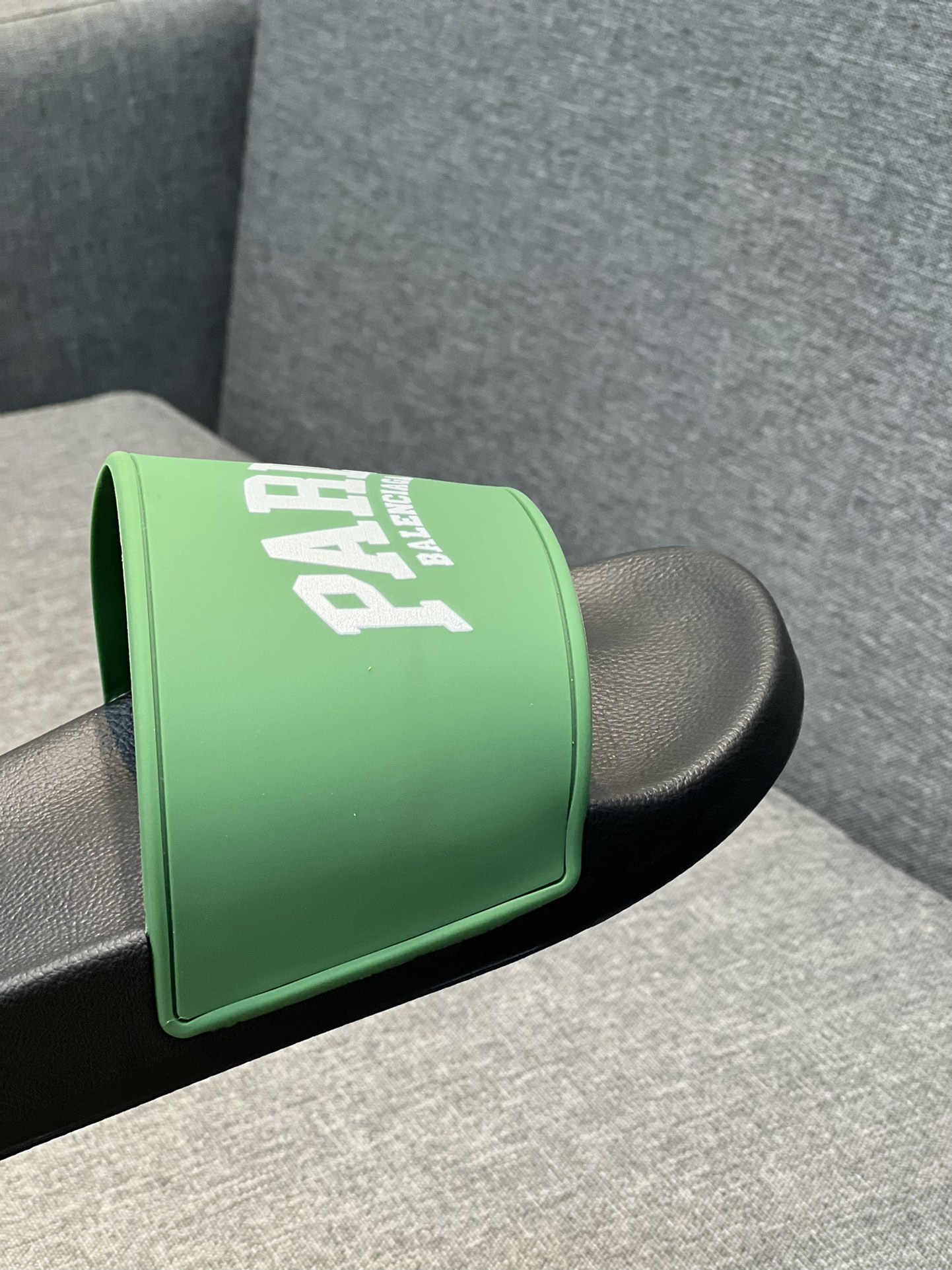 Balenciaga Paris pool slide sandals in green and black rubber.