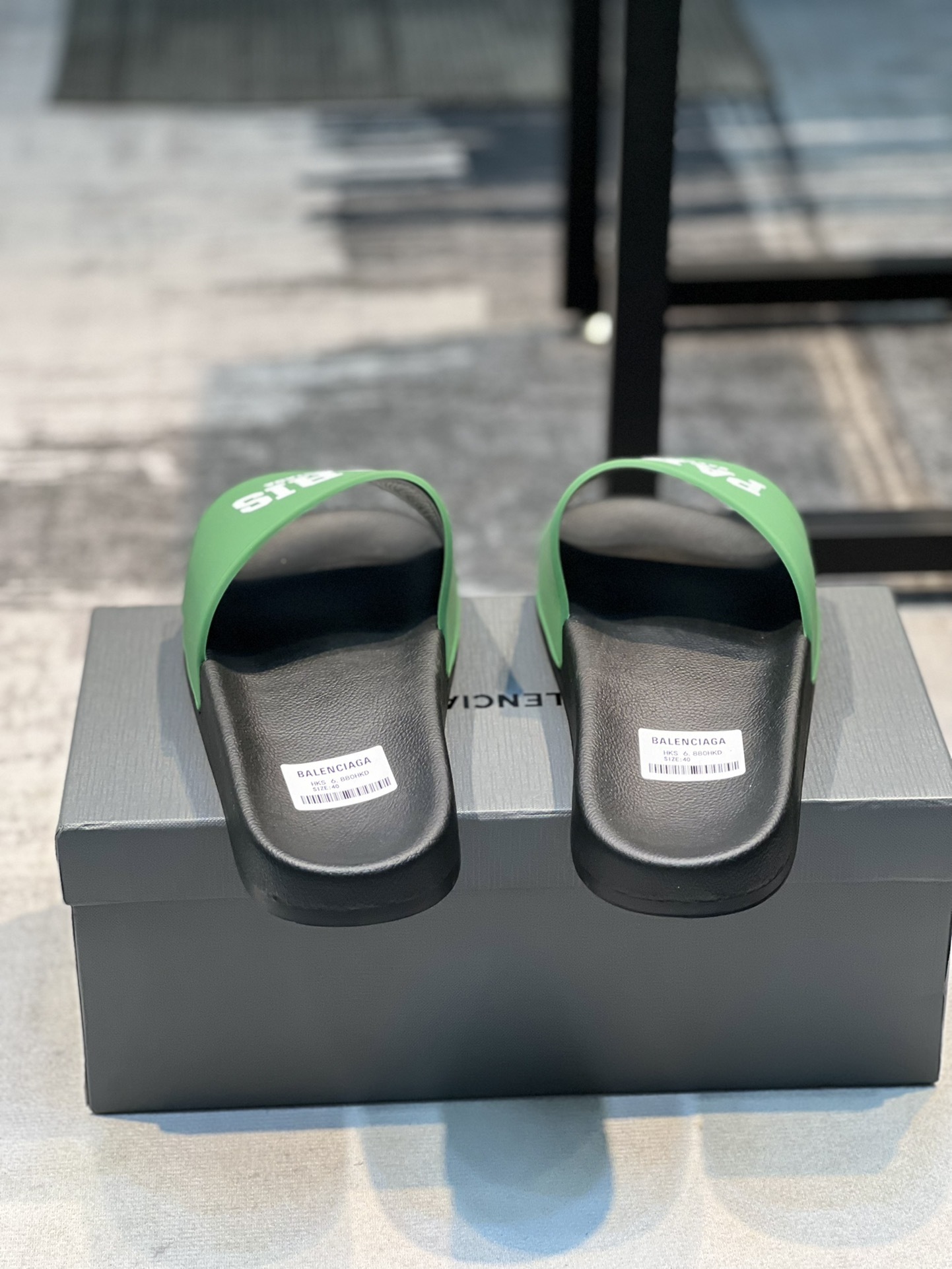 Balenciaga Paris pool slide sandals in green and black rubber.