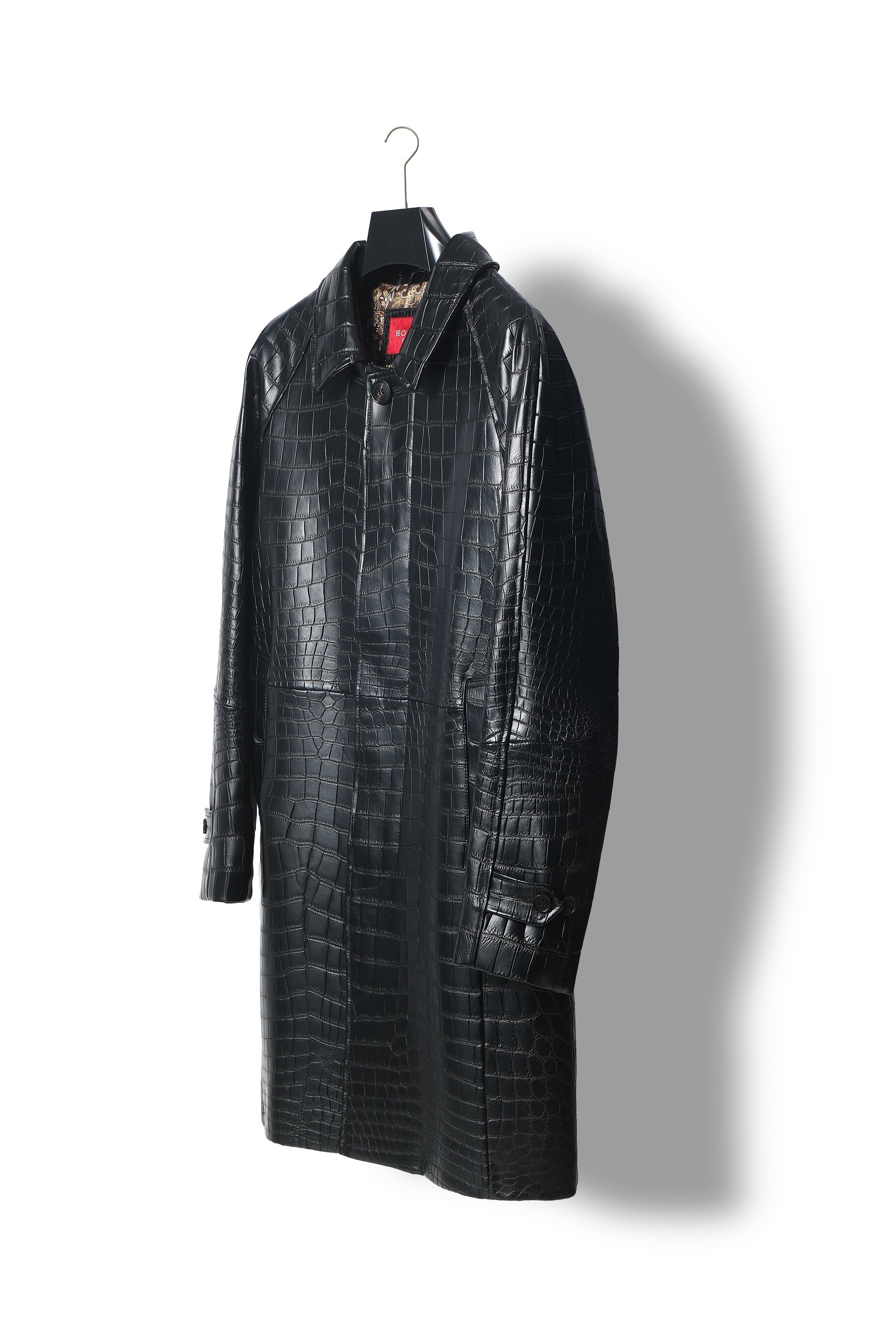 black crocodile-embossed leather coat or trench coat.