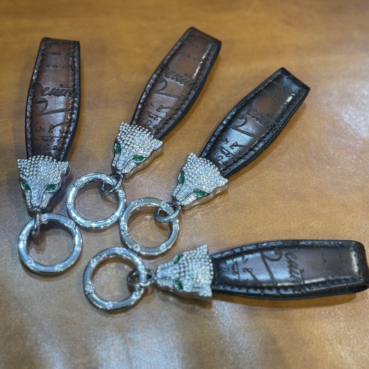 Berluti brown leather keychain with a rhinestone-encrusted panther head charm and metal ring.