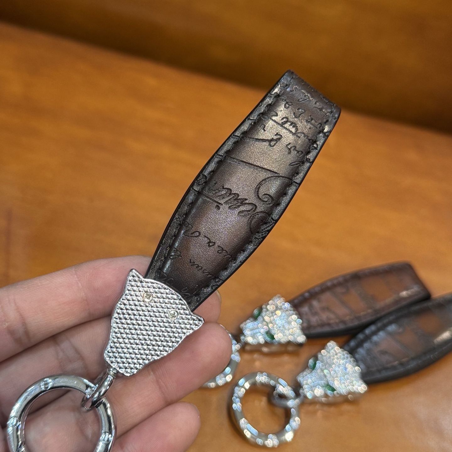 Berluti brown leather keychain with a rhinestone-encrusted panther head charm and metal ring.