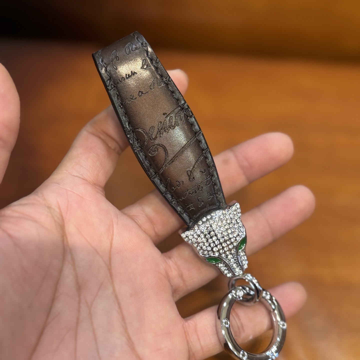 Berluti brown leather keychain with a rhinestone-encrusted panther head charm and metal ring.