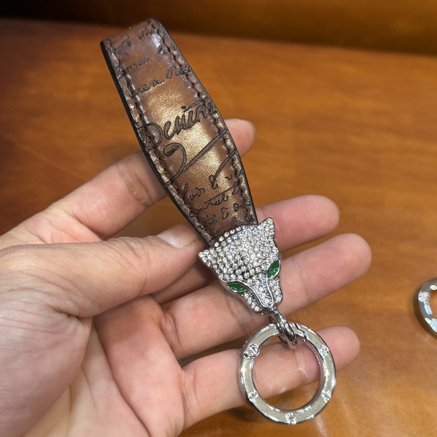 Berluti brown leather keychain with a rhinestone-encrusted panther head charm and metal ring.