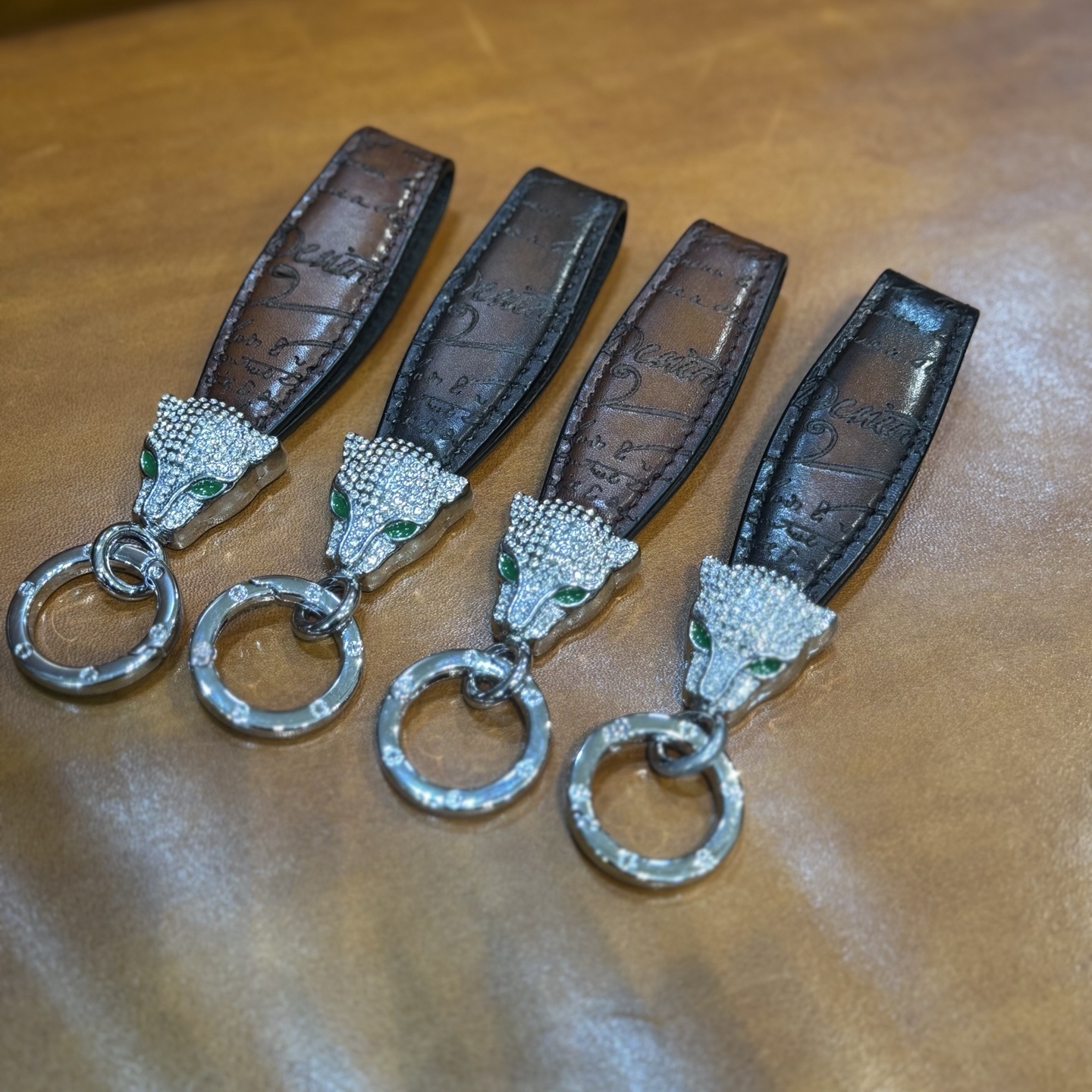 Berluti brown leather keychain with a rhinestone-encrusted panther head charm and metal ring.