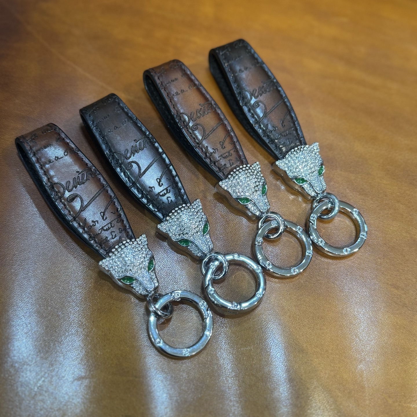 Berluti brown leather keychain with a rhinestone-encrusted panther head charm and metal ring.