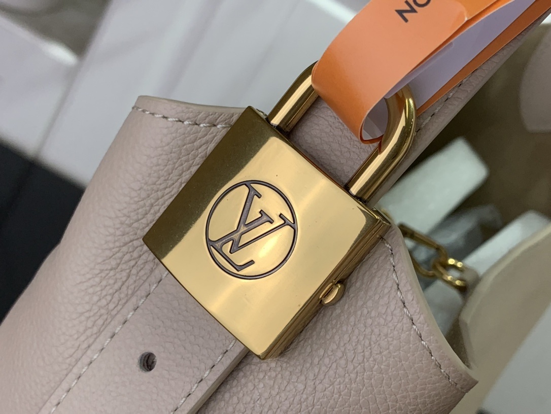 LV Low Key Hobo MM handbag in smooth grained calfskin leather and a limestone color